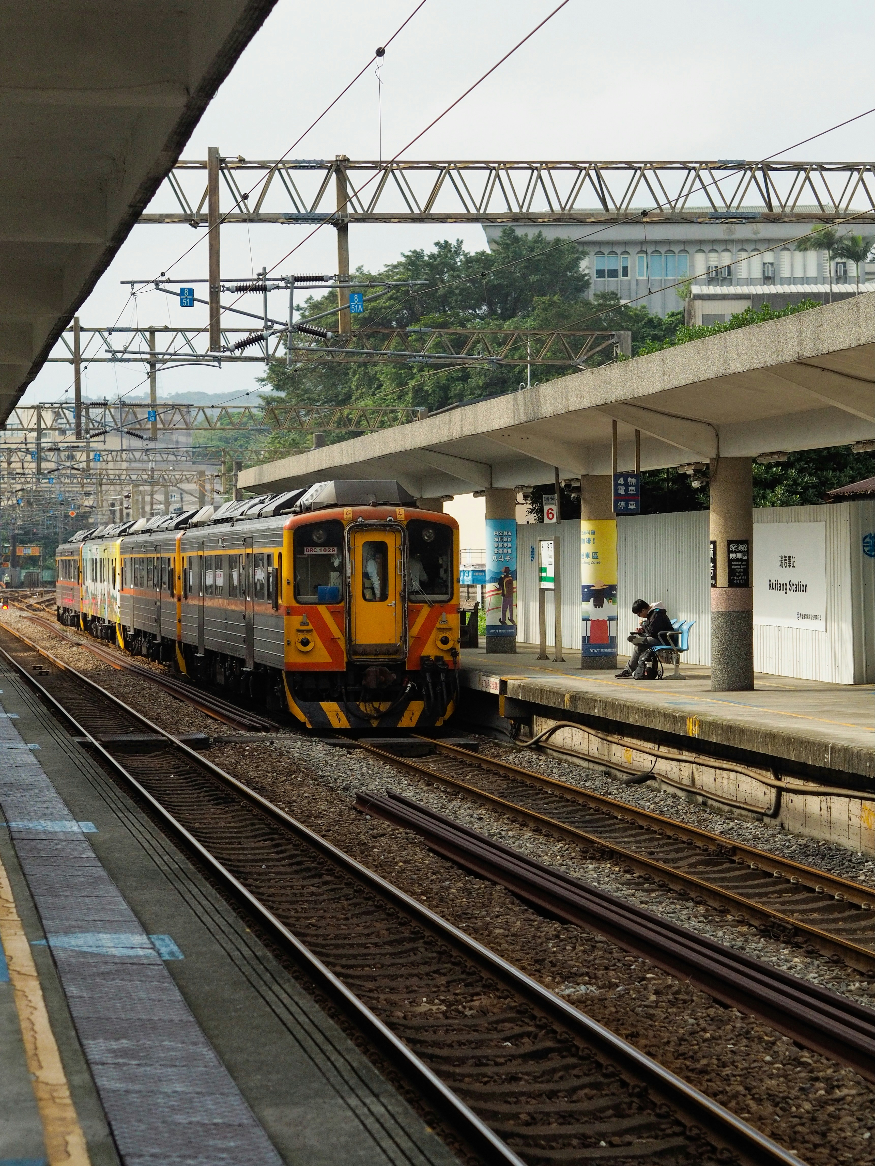 A train waits at a station platform.