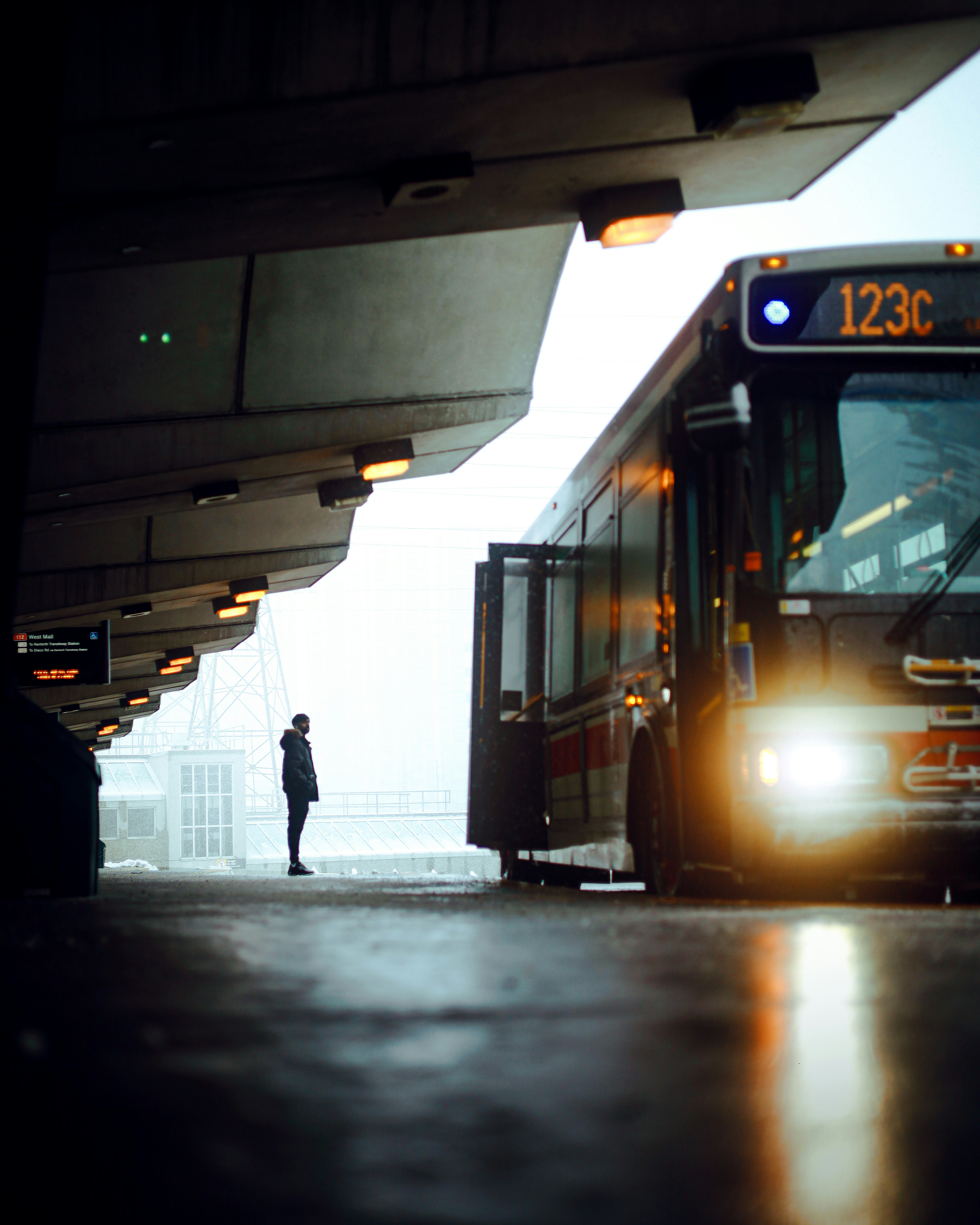 Person waiting for bus at station in a station