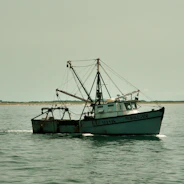 A fishing boat sails on the water.