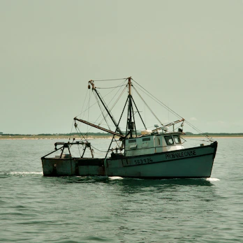A fishing boat sails on the water.