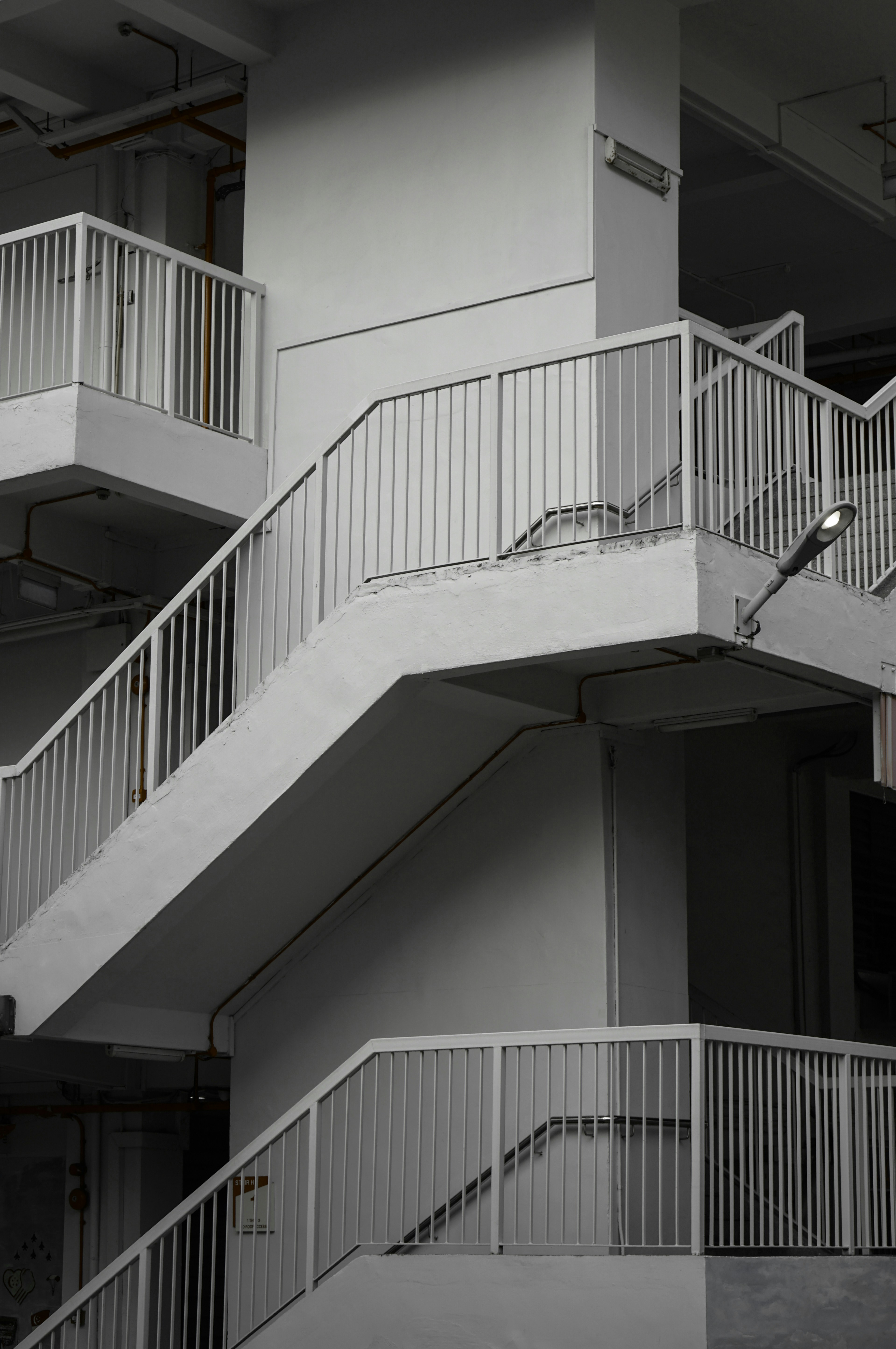 Concrete staircase with white railings and lights