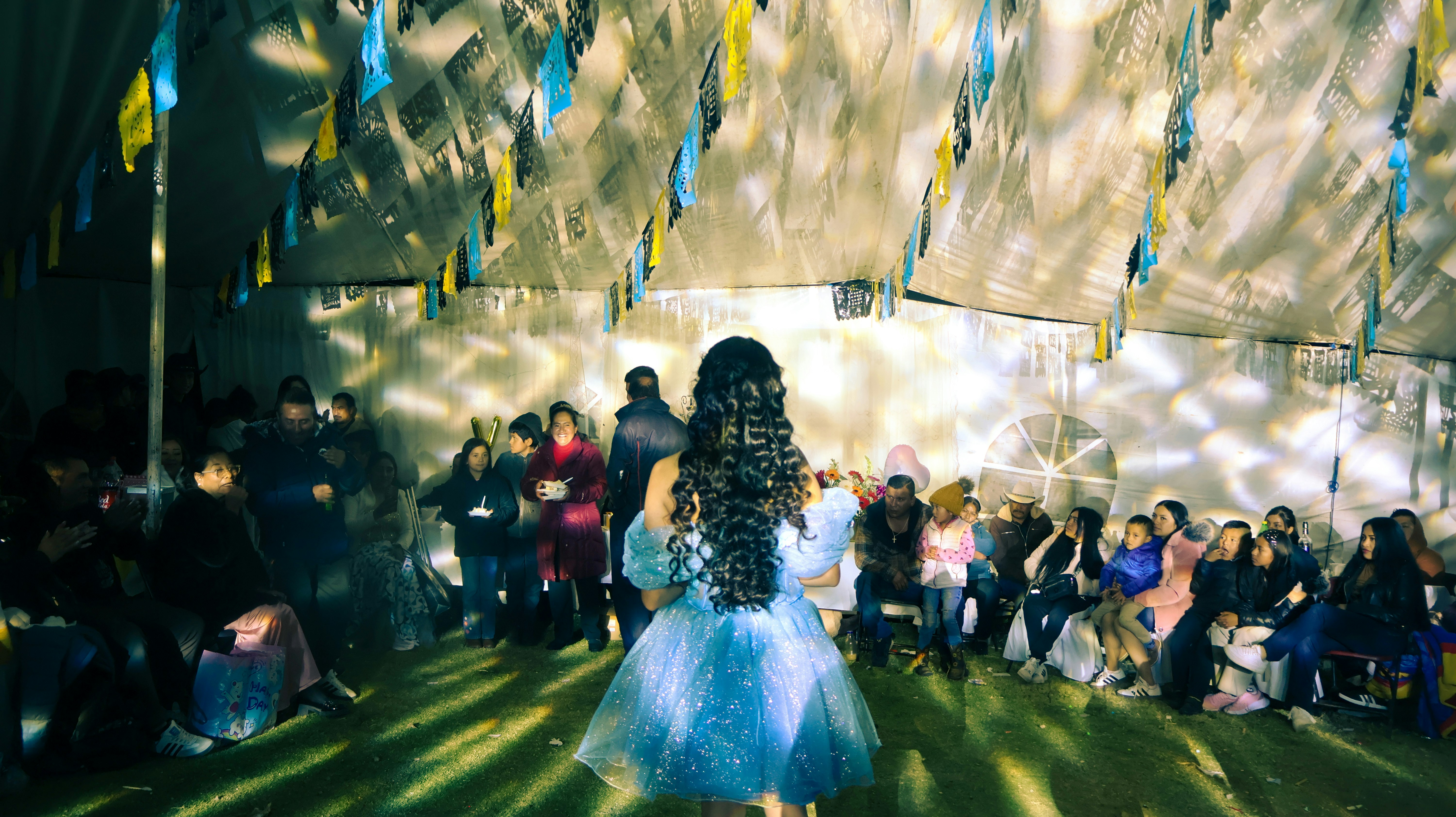 A girl in a sparkly dress on a runway.