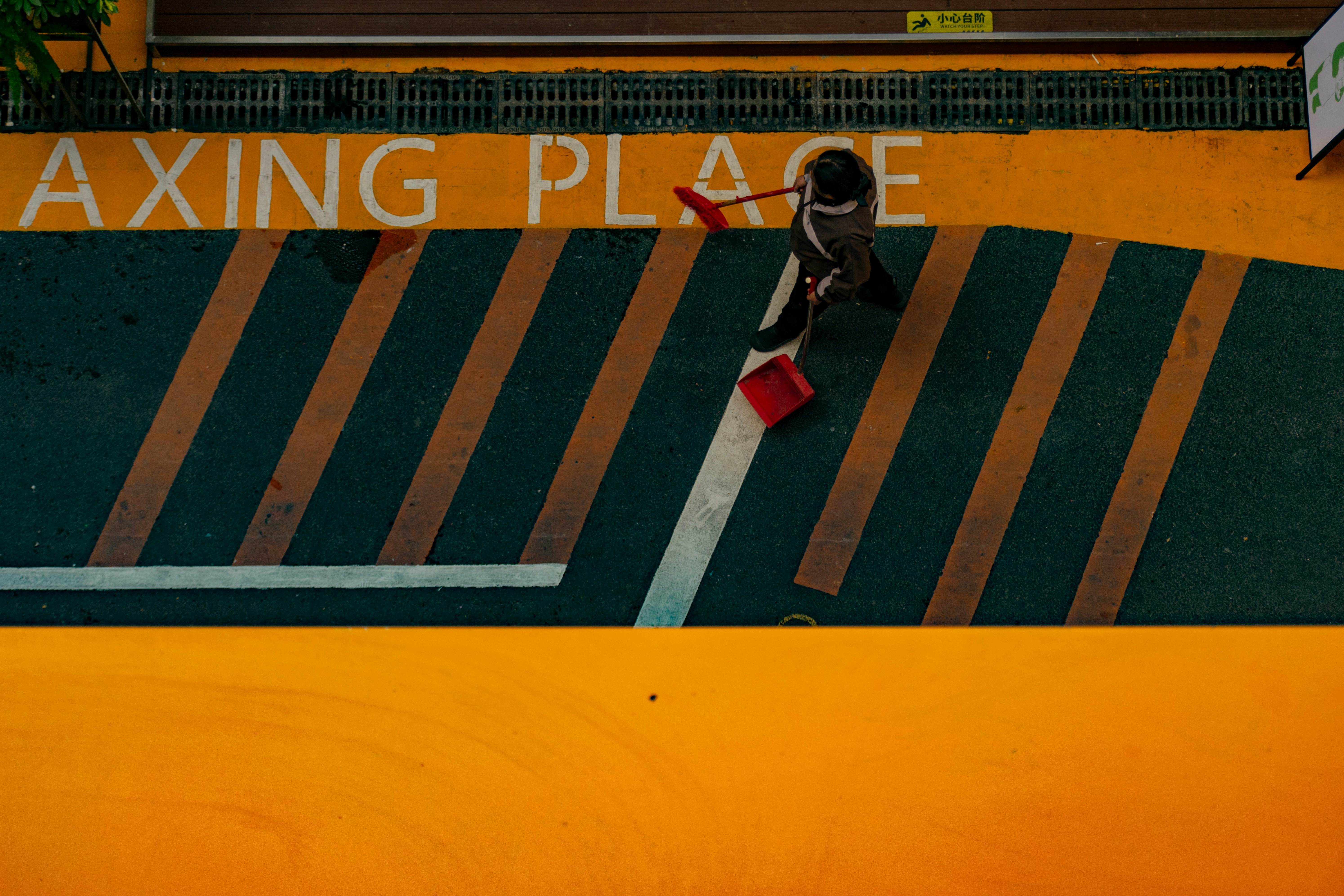A person walking on a yellow and green striped surface.