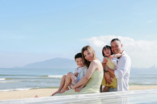 Family posing for a picture at the beach