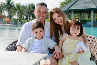A happy family of four by the pool.