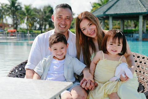 A happy family of four by the pool.