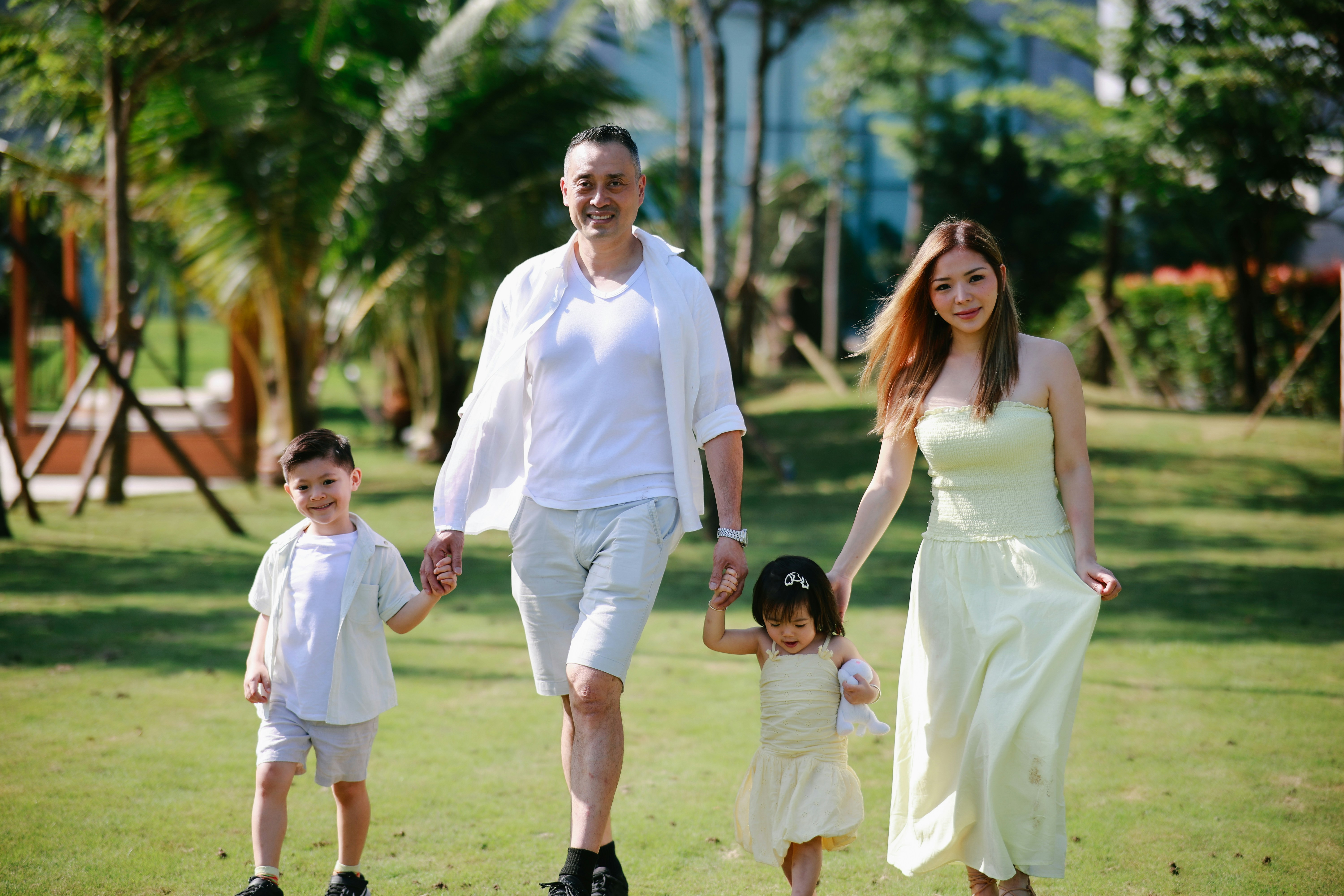 Family walking together on grassy lawn