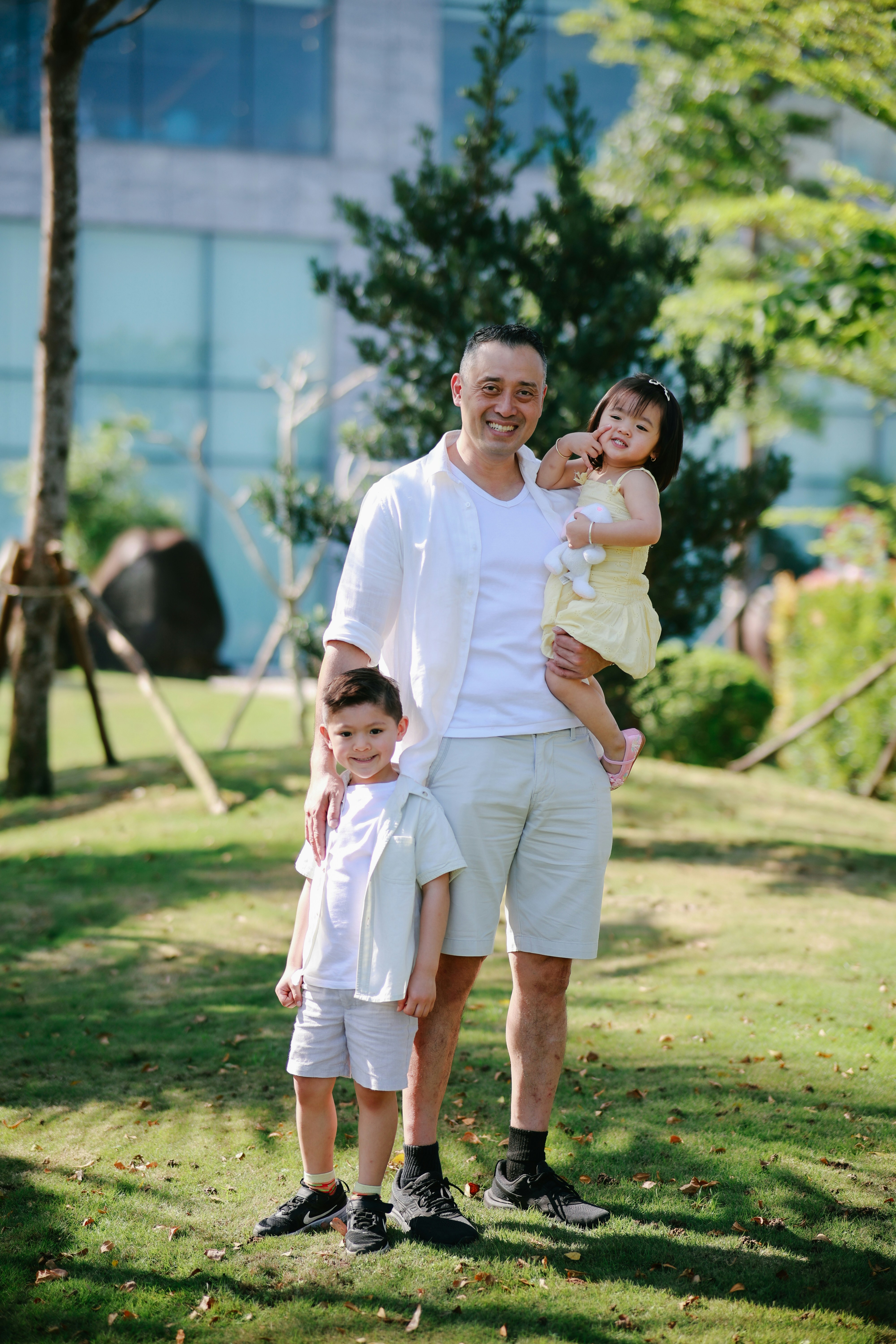 Father with two children in a park