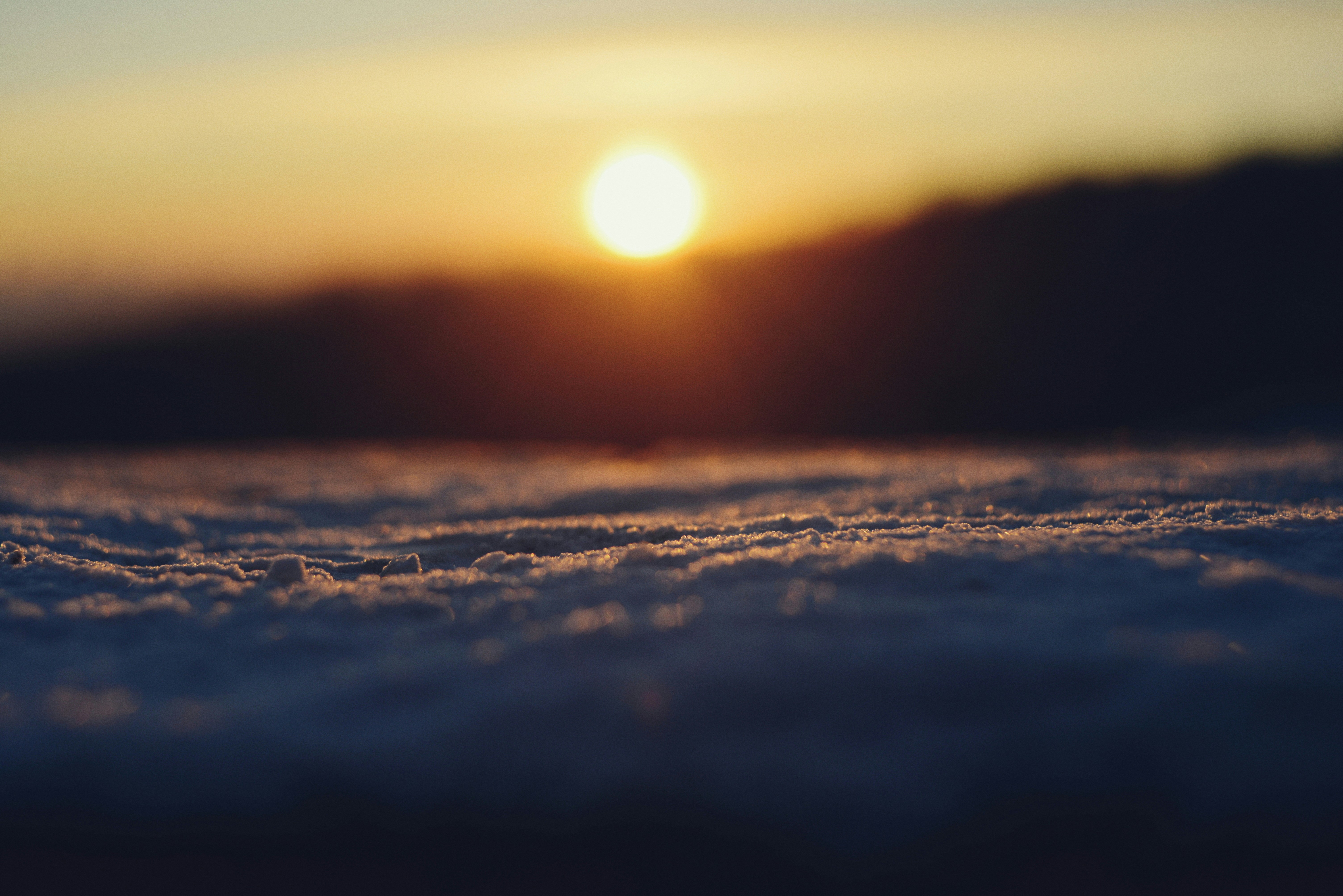 Sun setting over a snowy landscape