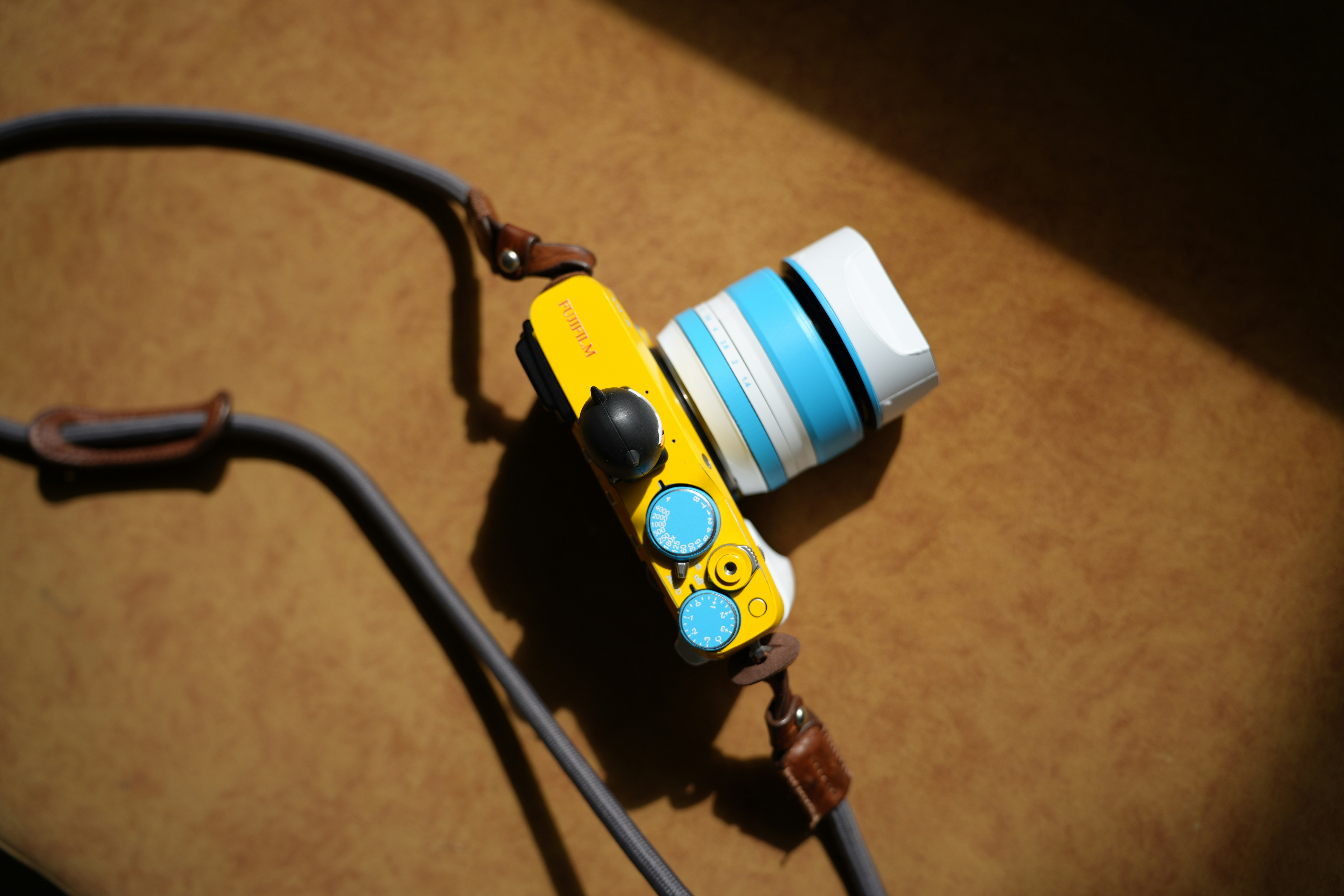 A yellow camera with a blue and white lens.