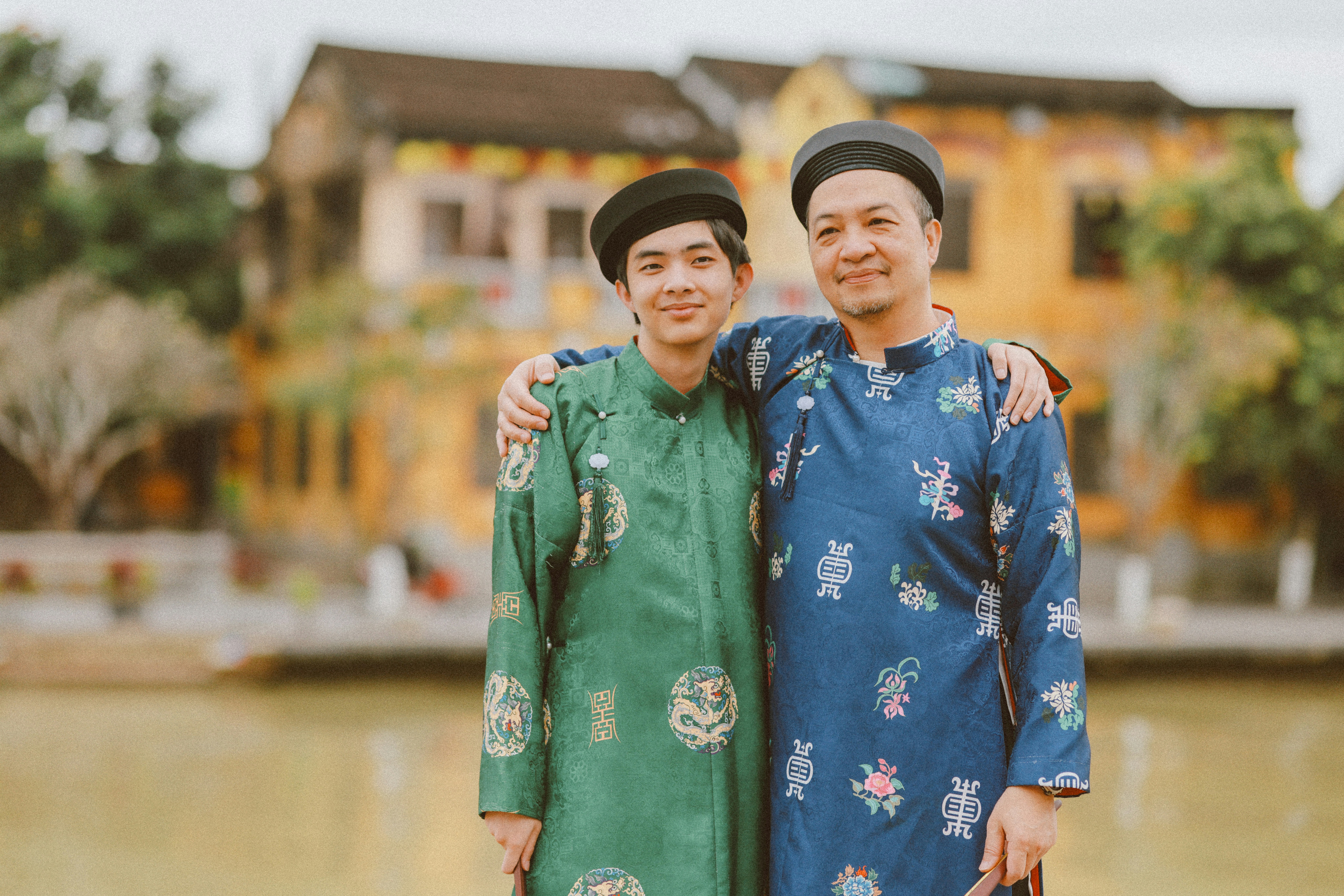 Two men in traditional vietnamese ao dai attire.