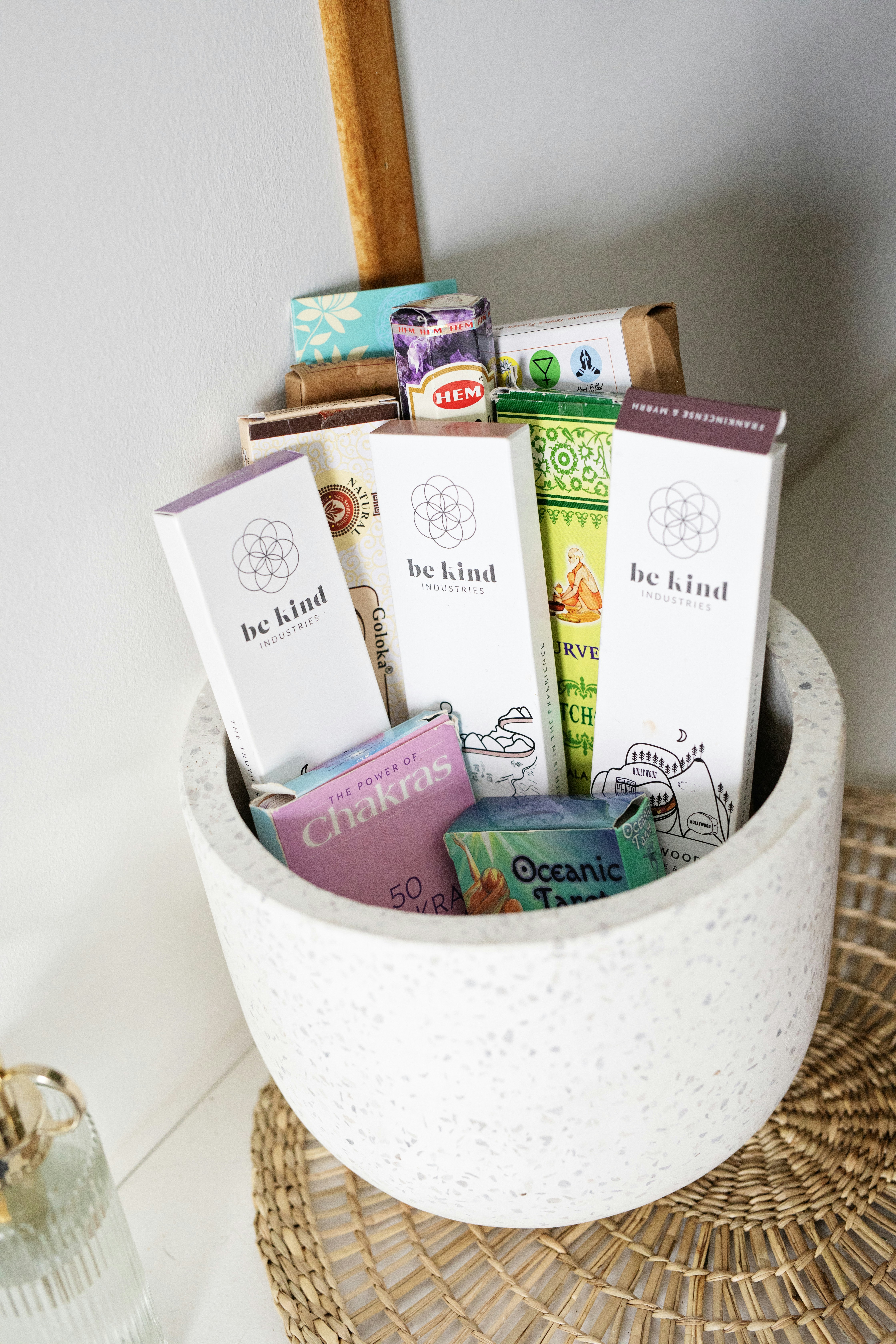 Incense sticks and boxes in a white pot.