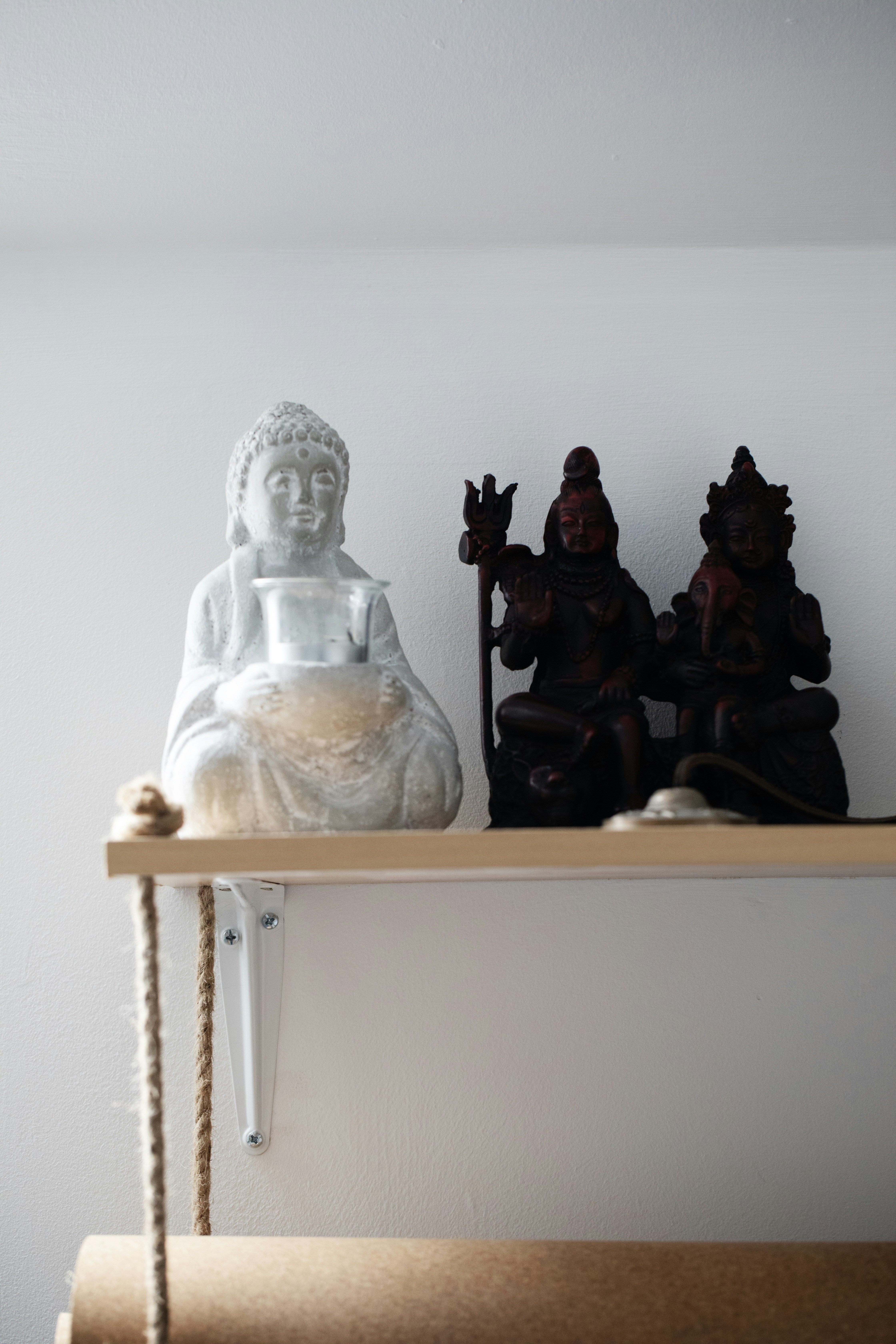 Buddha and hindu deities on a shelf