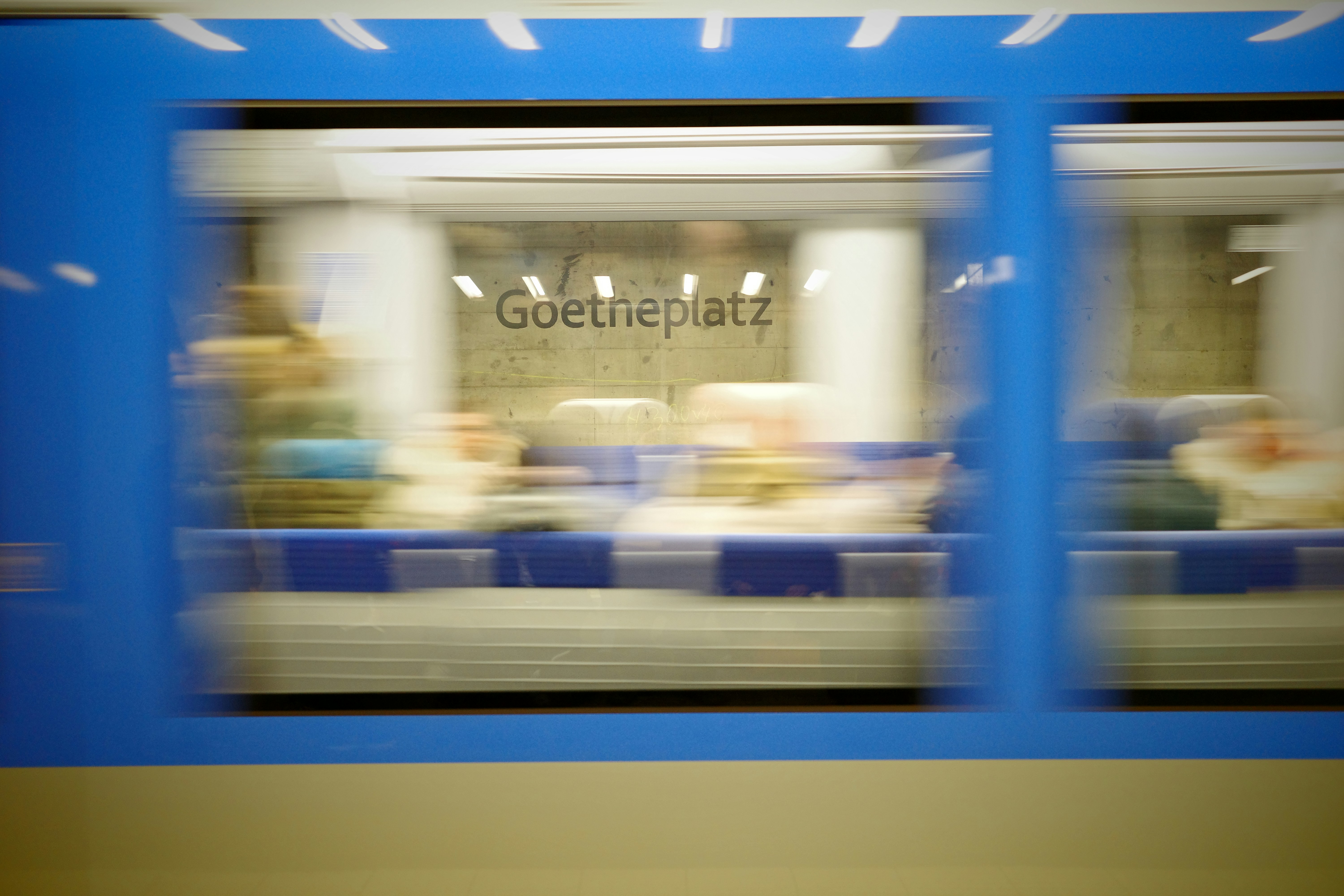 Blurry view of a subway train interior in motion