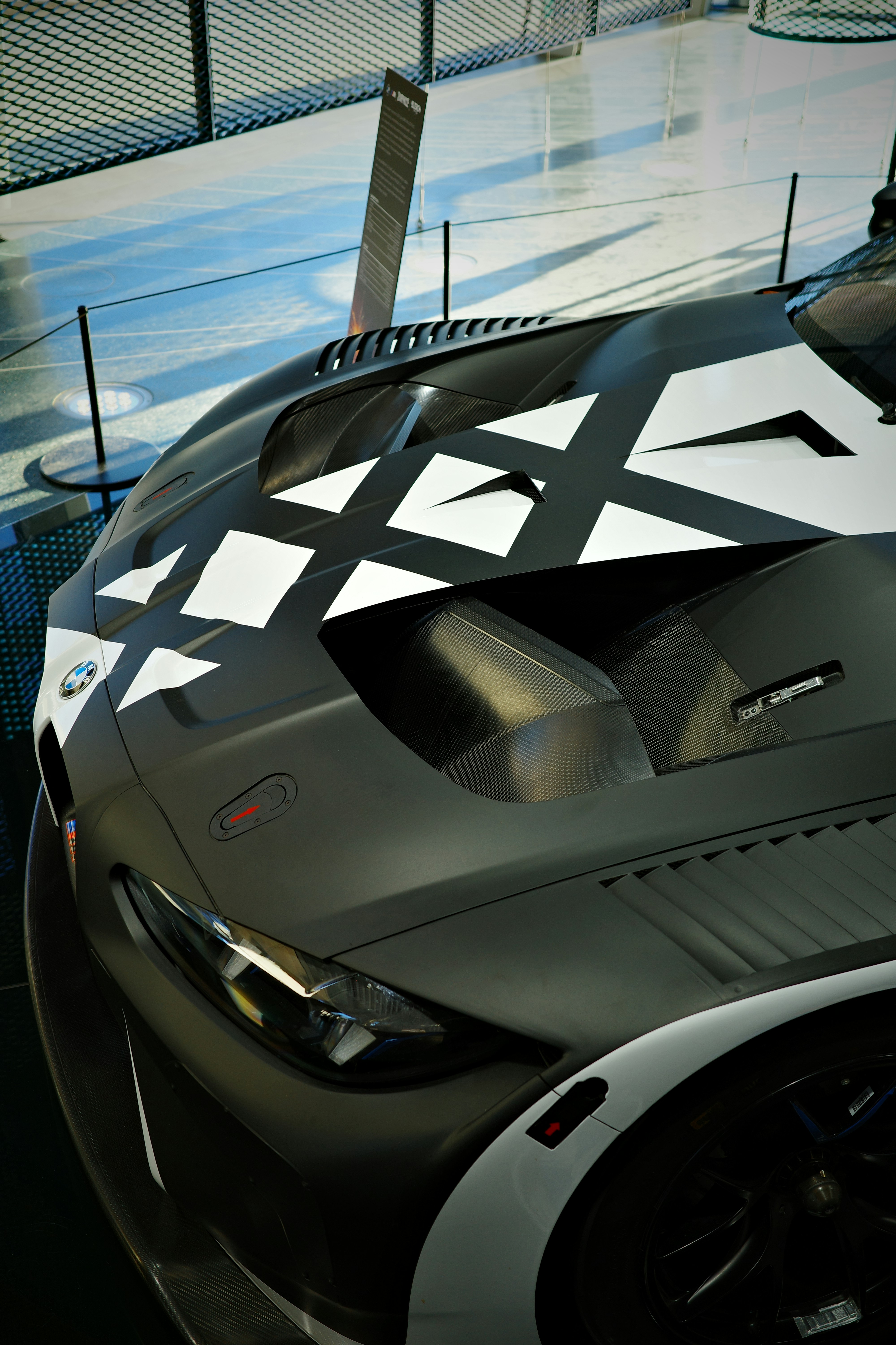 Sleek race car with black and white geometric design