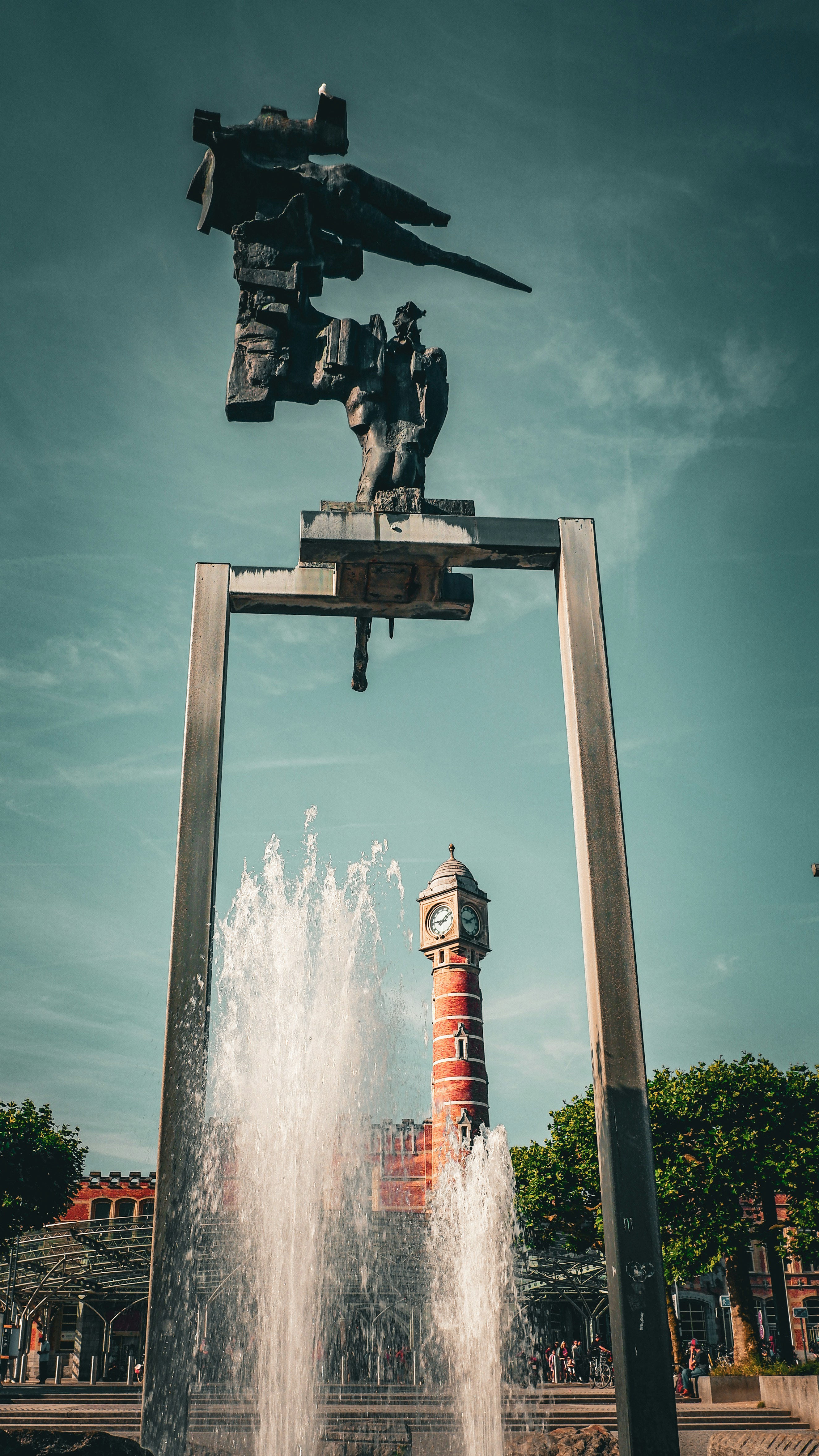 Modern sculpture with fountain and clock tower