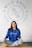 Woman sitting cross-legged in yoga studio