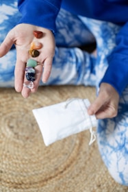 Seven colorful crystals arranged on a palm