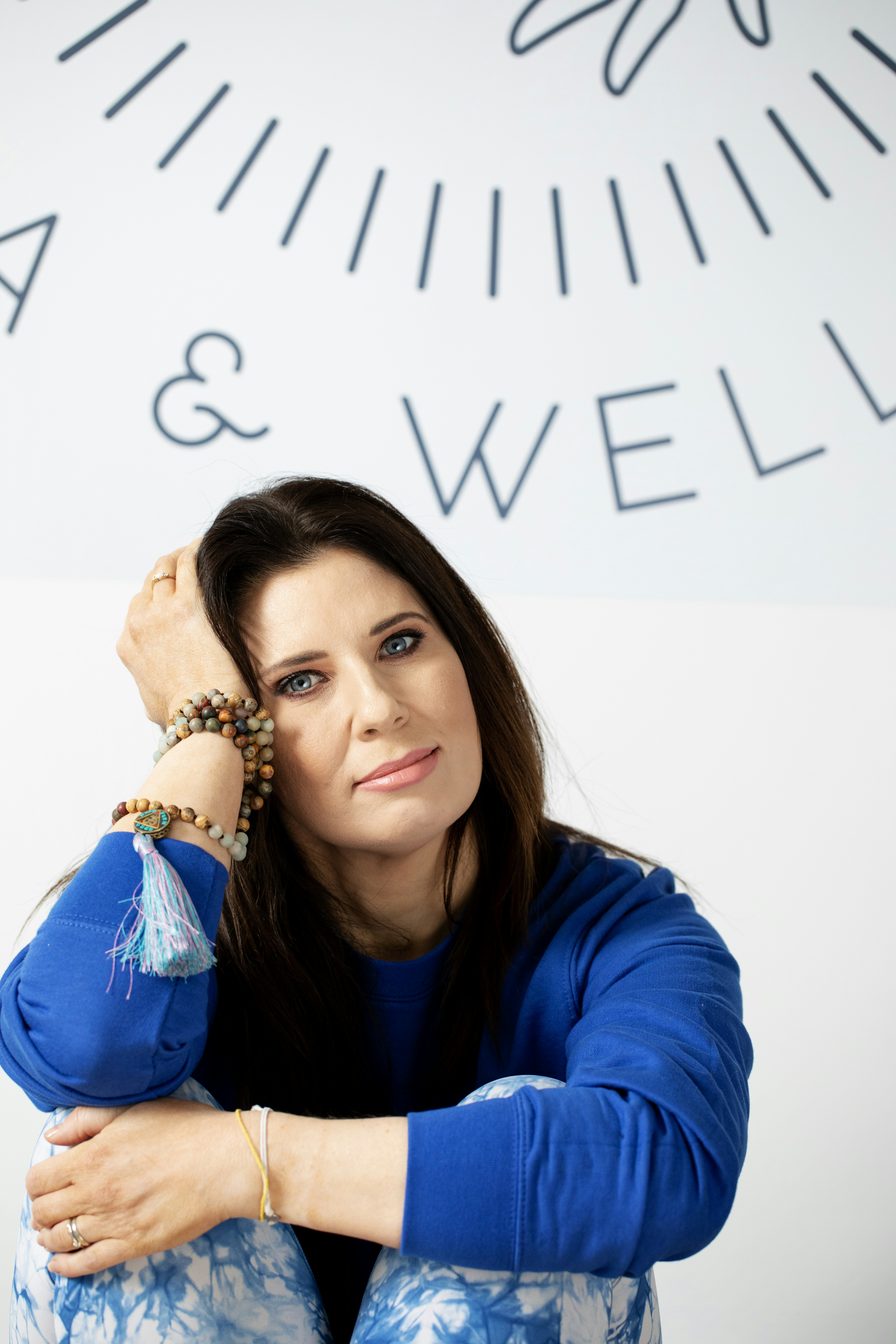 Woman with bracelets and blue sweatshirt