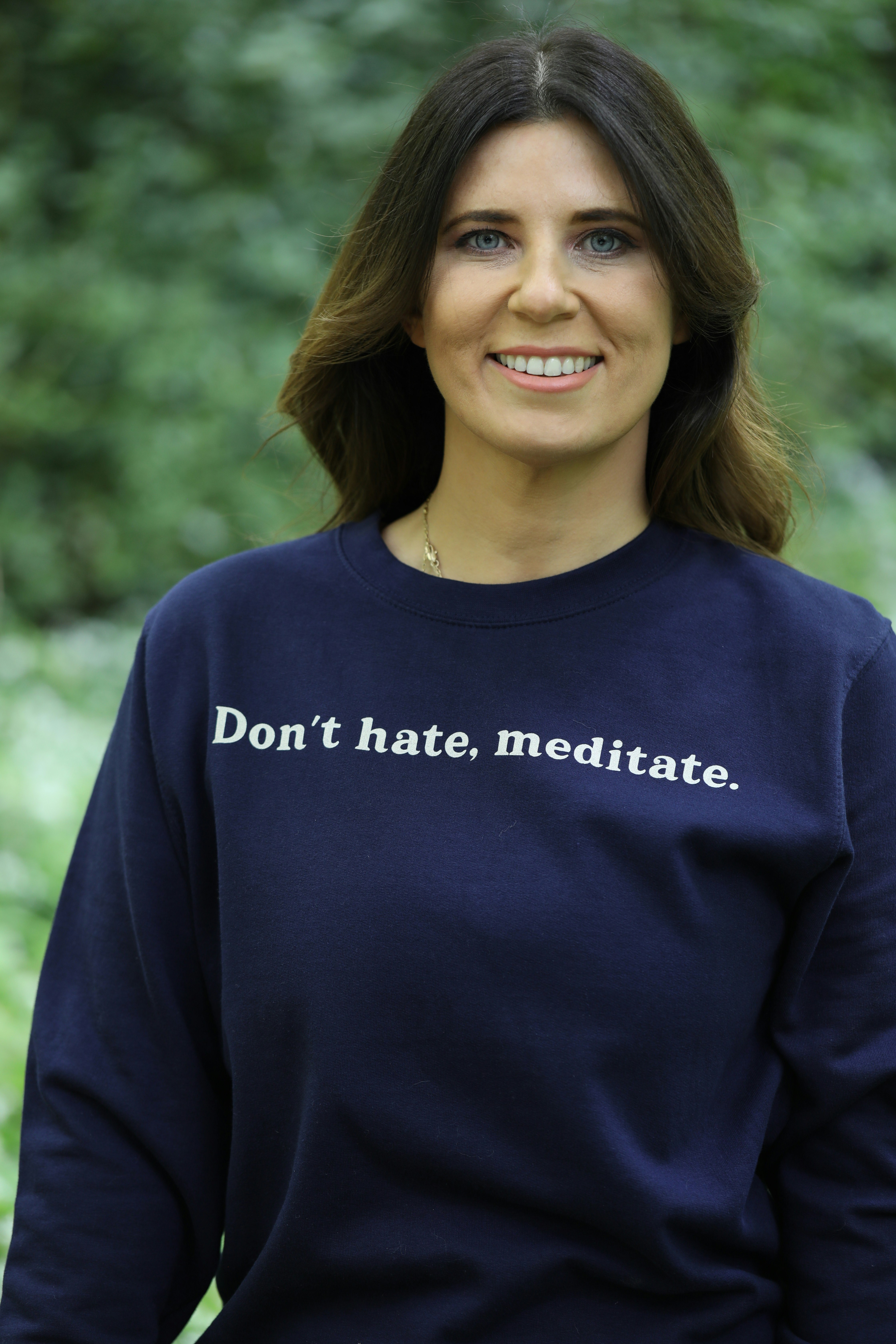 Woman wearing a sweatshirt with text.