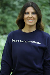 Woman wearing a sweatshirt with text.