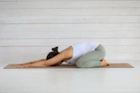 Woman in child's pose on yoga mat