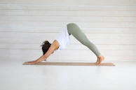 Woman practicing downward-facing dog yoga pose.