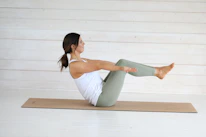 Woman in boat pose on yoga mat