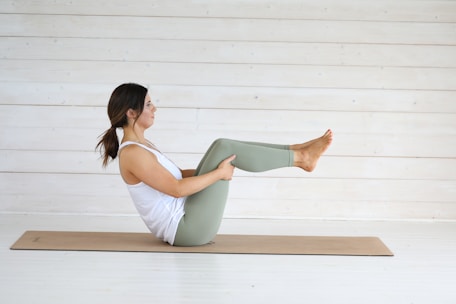 Woman in boat pose on yoga mat