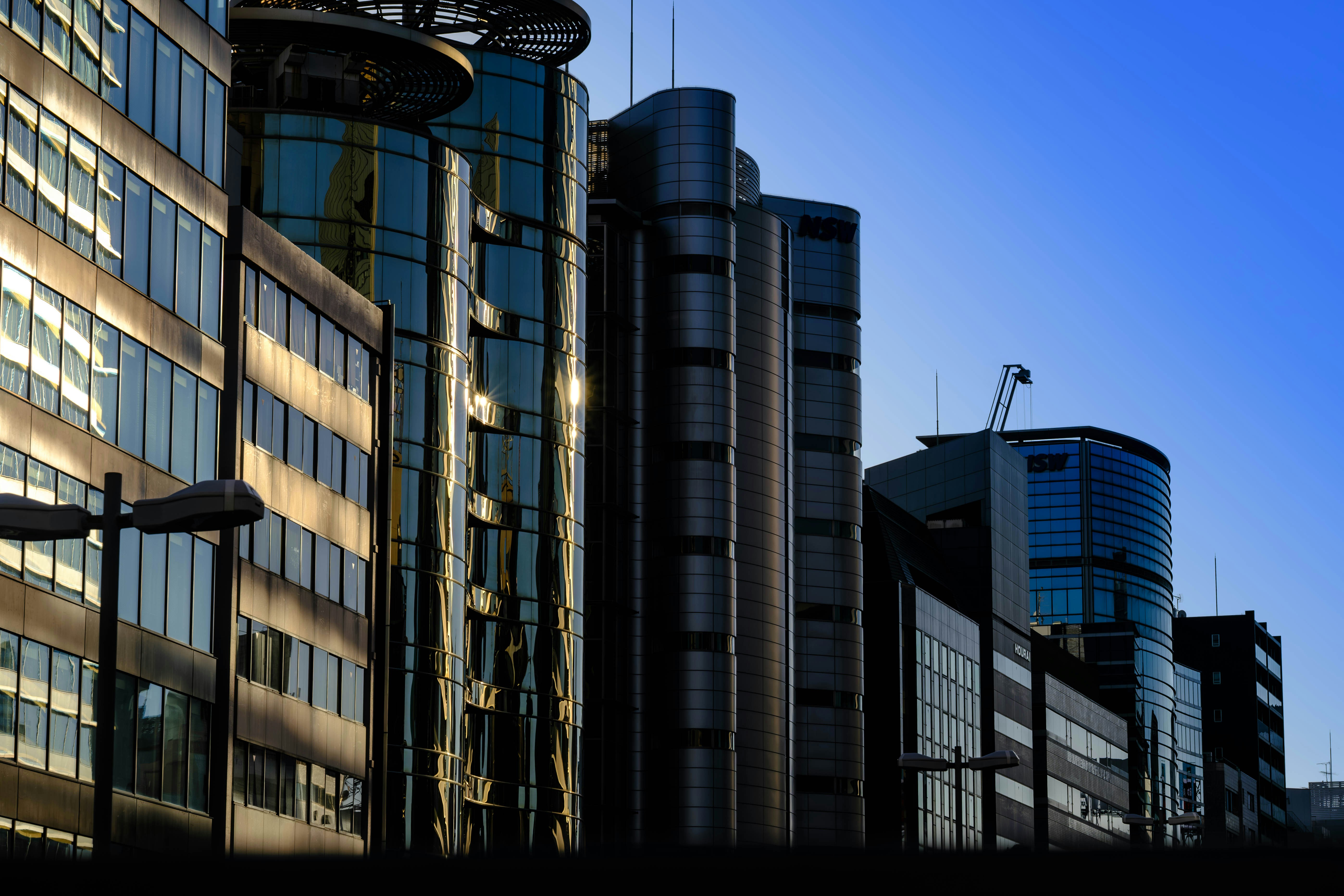 Modern office buildings against a clear blue sky.