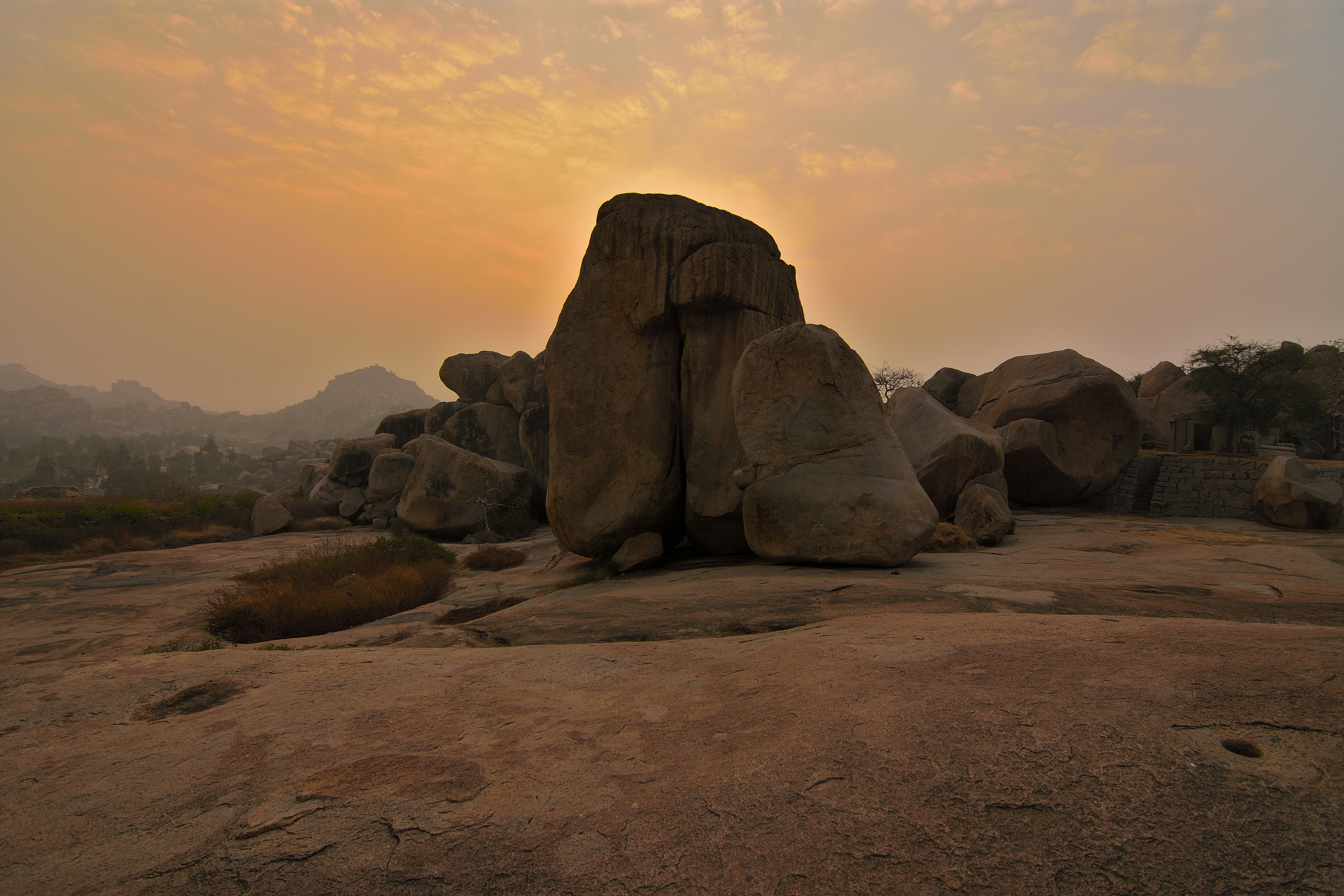 Large rock formations on a rocky landscape at sunset