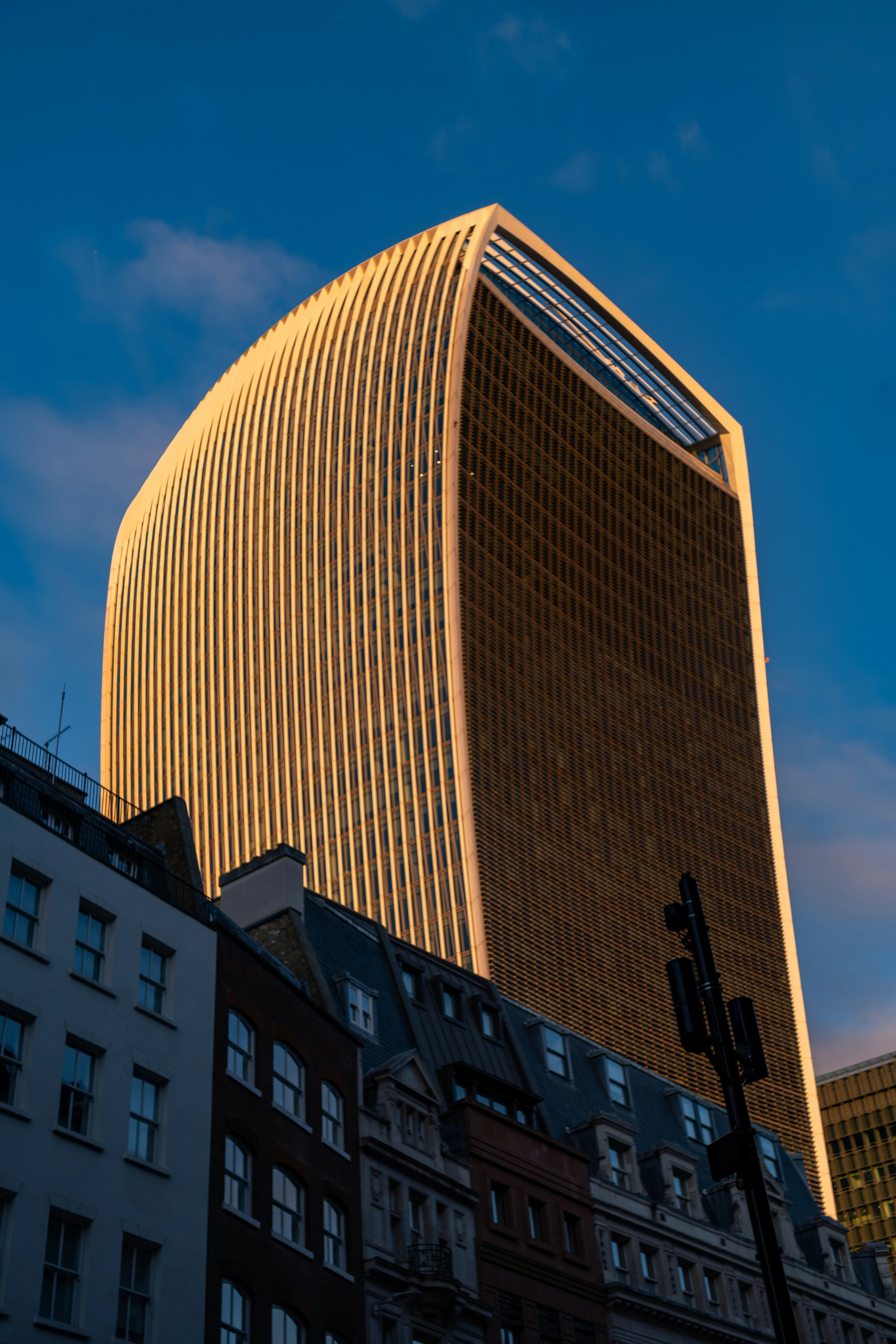 Modern skyscraper illuminated by golden sunset light