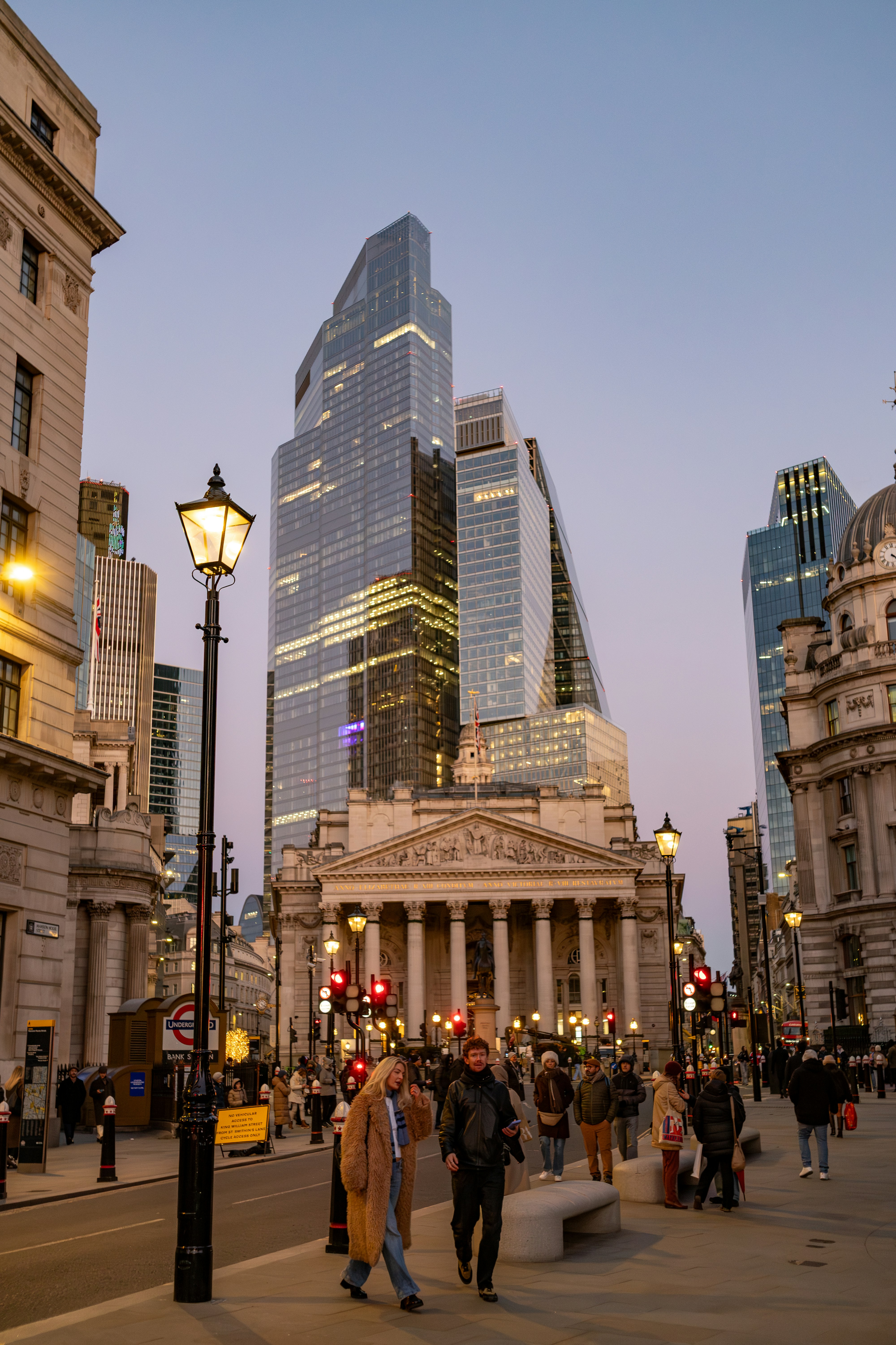 City street with modern skyscrapers and classical architecture.