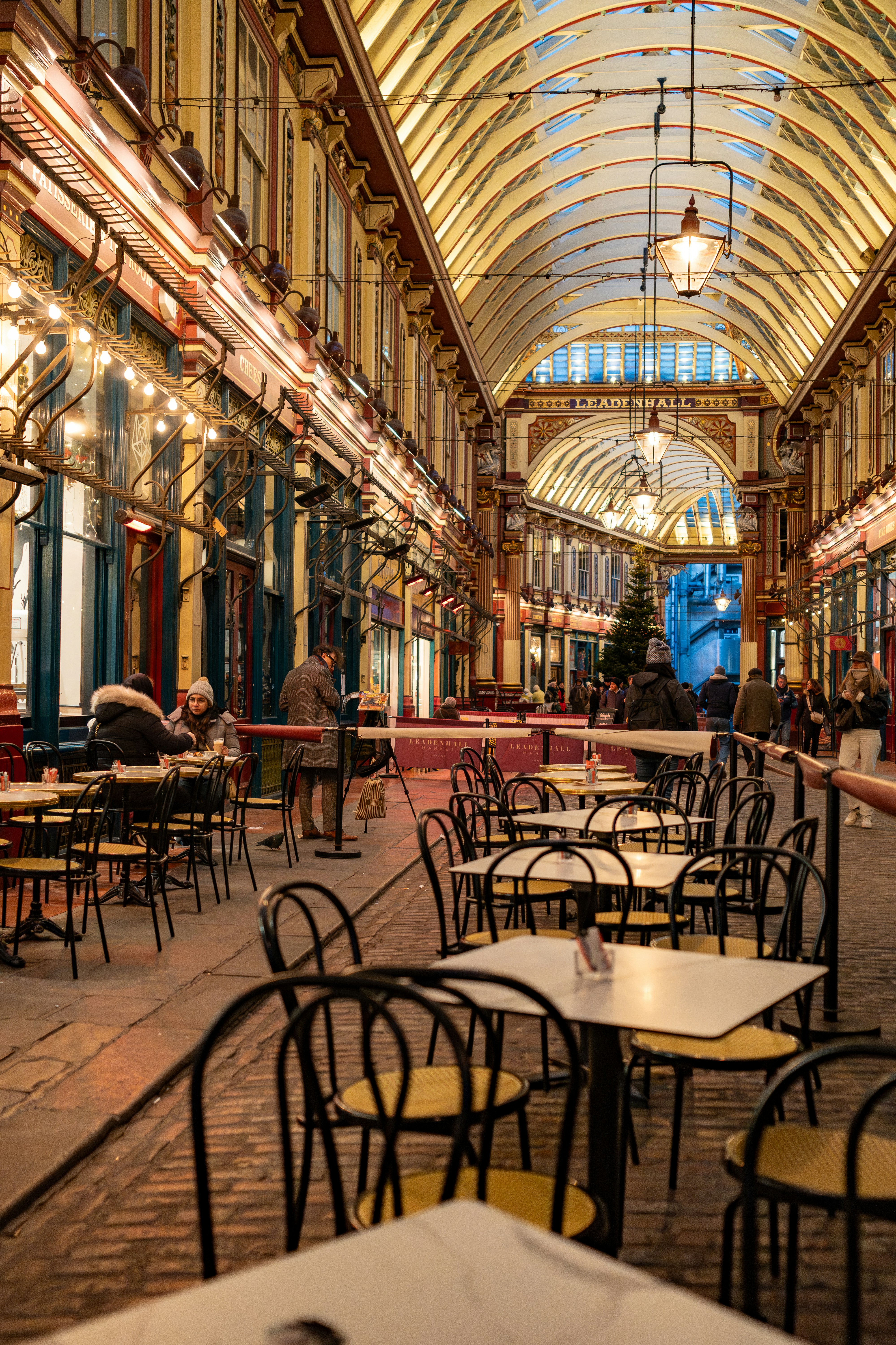 People dining in a historic indoor market with ornate architecture