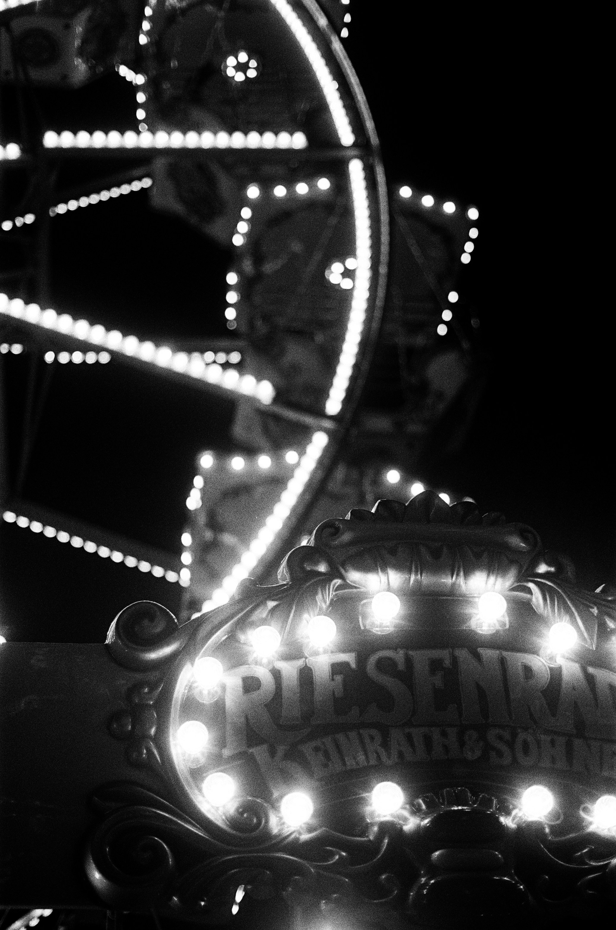 Ferris wheel illuminated with bright lights at night
