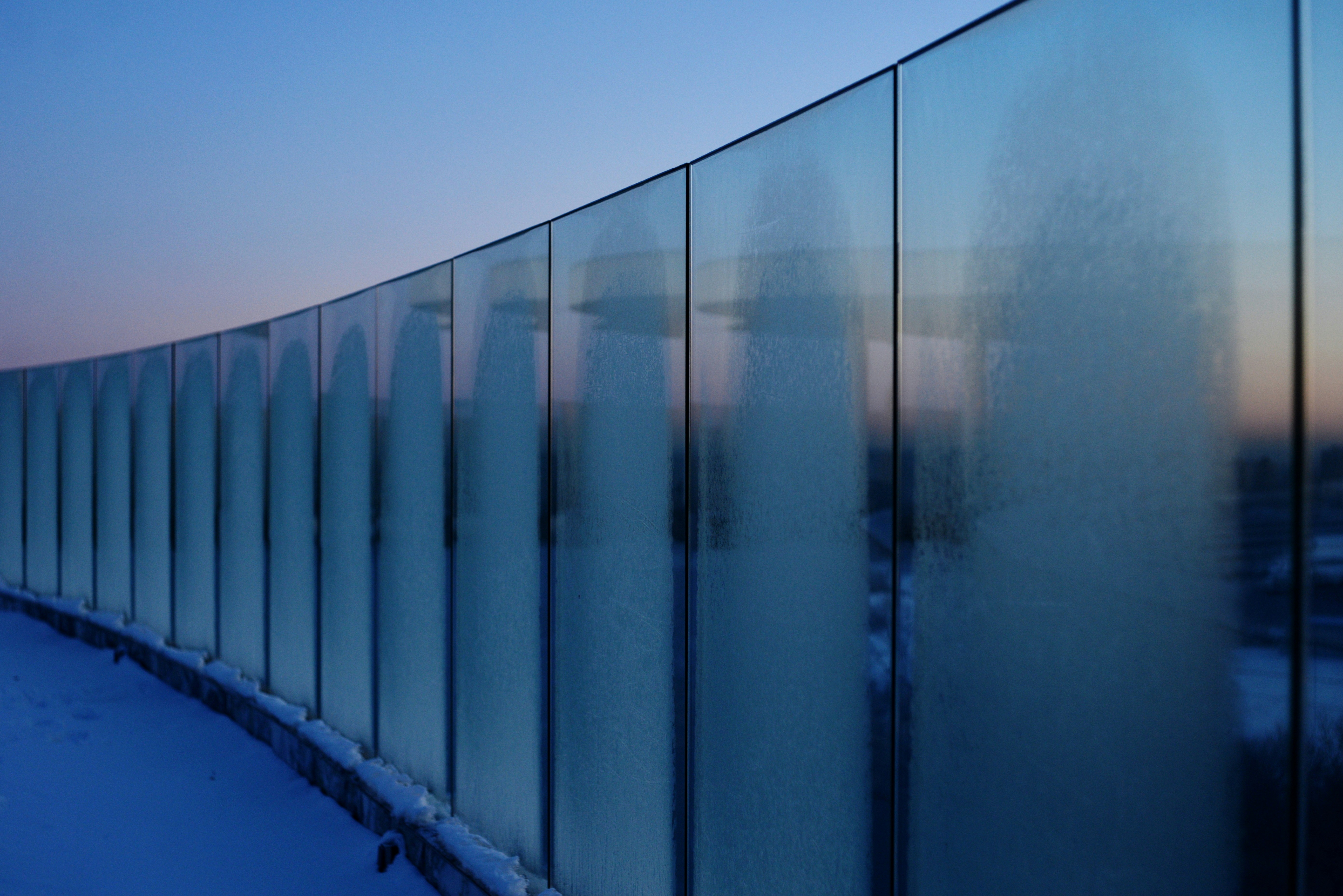 Frosted glass railing against a twilight sky