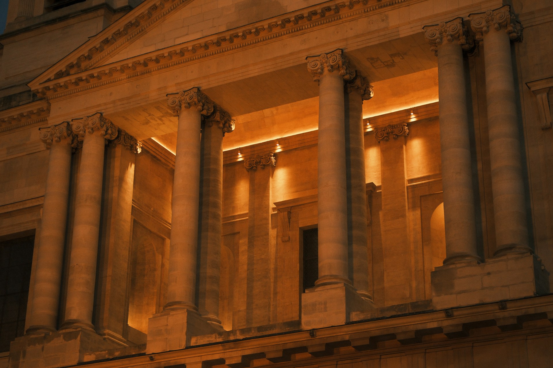 Grand building facade with illuminated classical columns