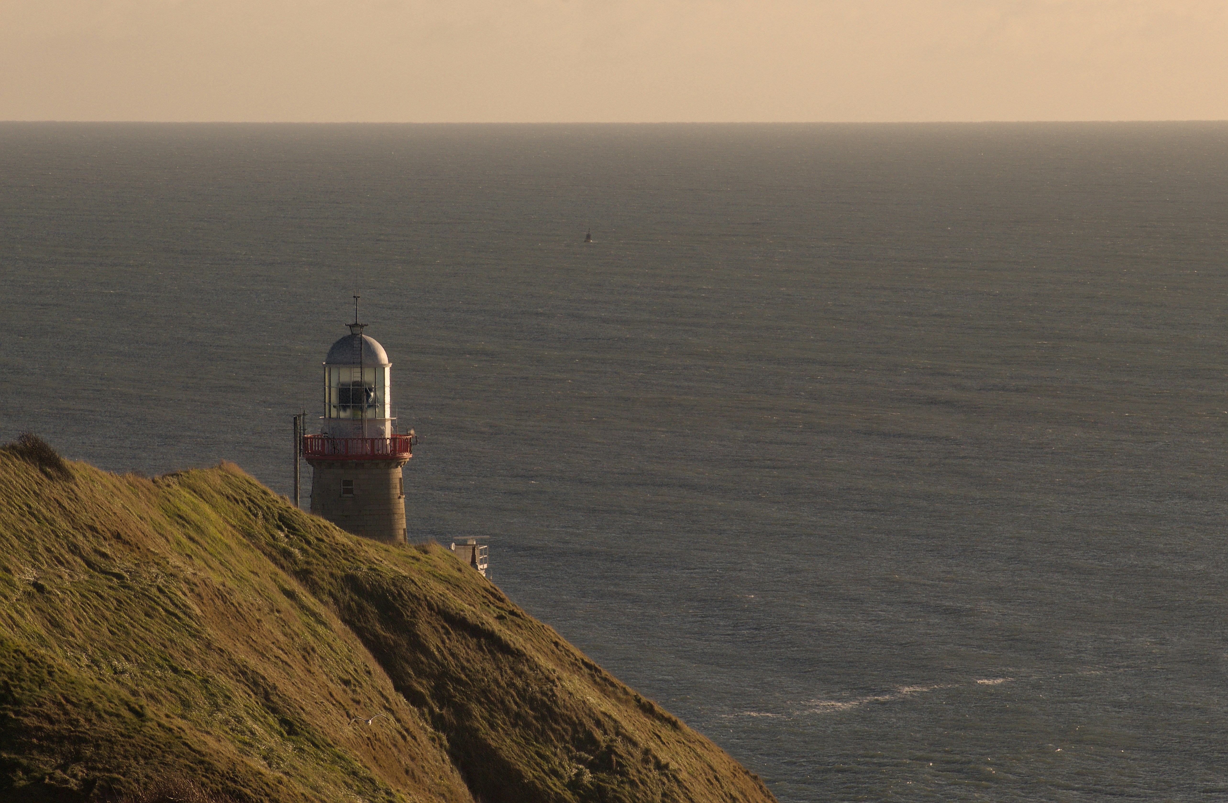 Lighthouse on a cliff overlooking the ocean
