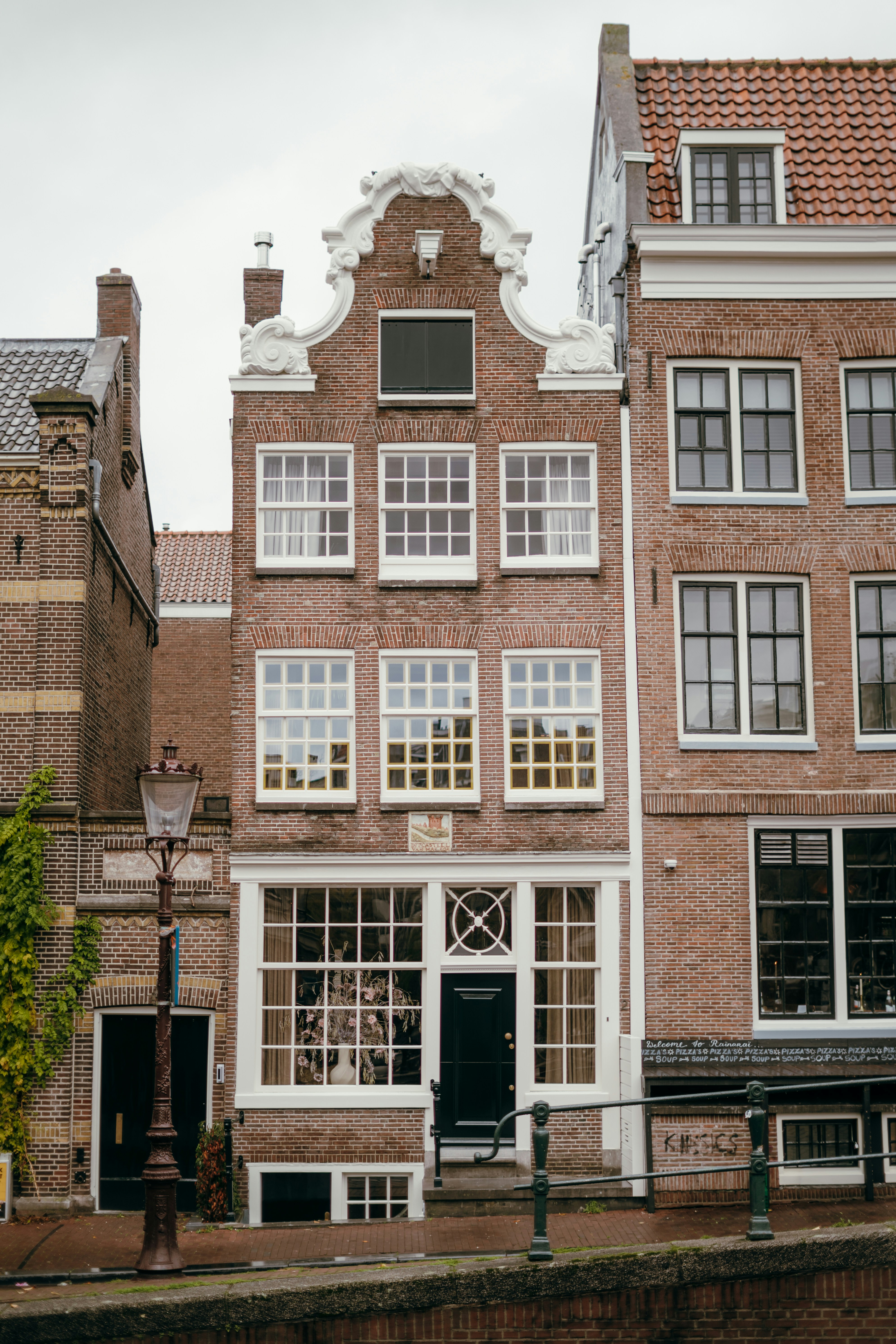 Tall brick building with many windows and ornate facade