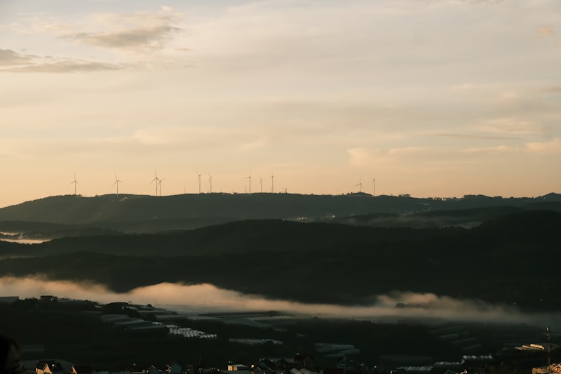 Wind turbines on rolling hills at sunrise