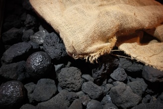 Pile of coal with a burlap sack