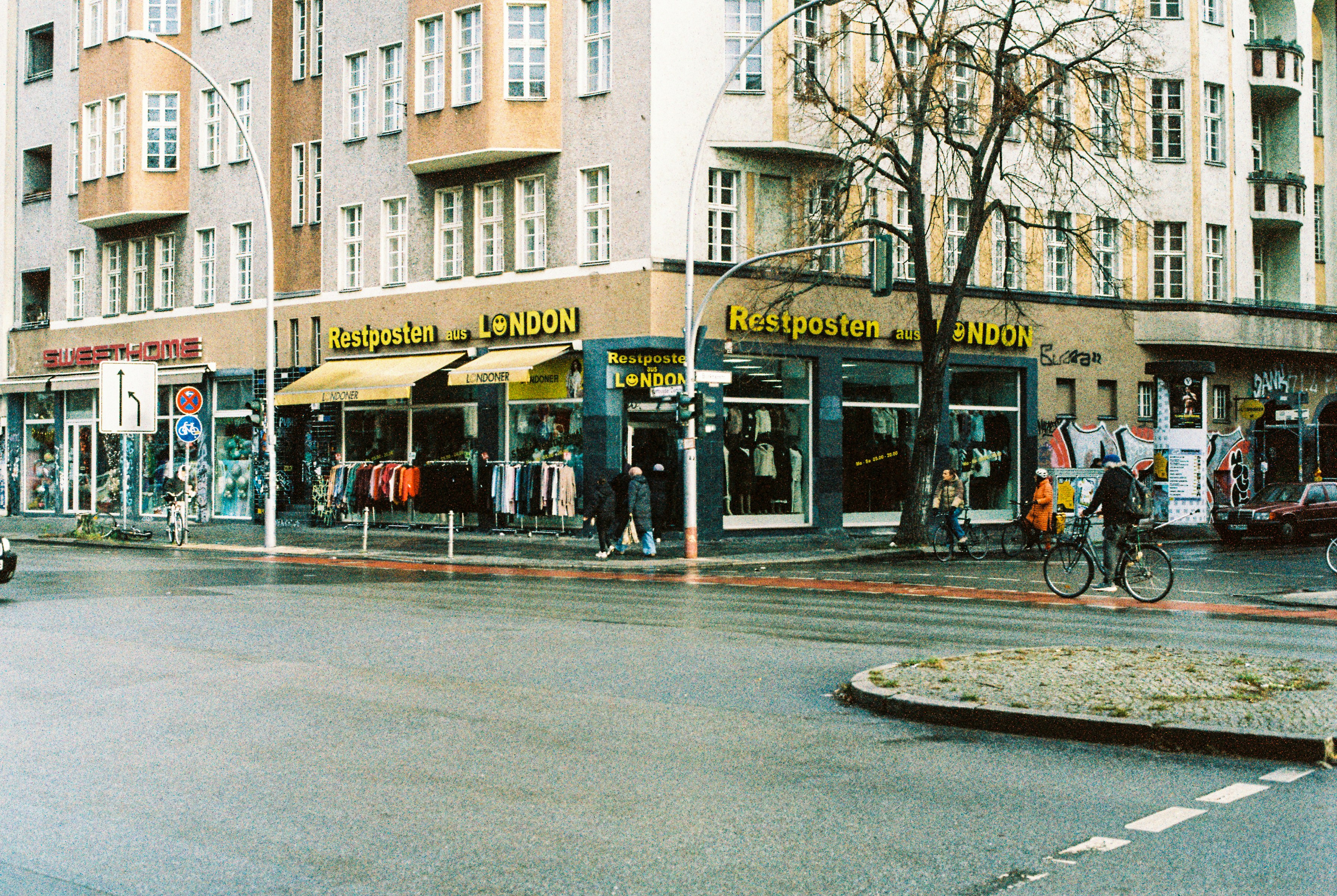 Street corner with shops and buildings on a rainy day.