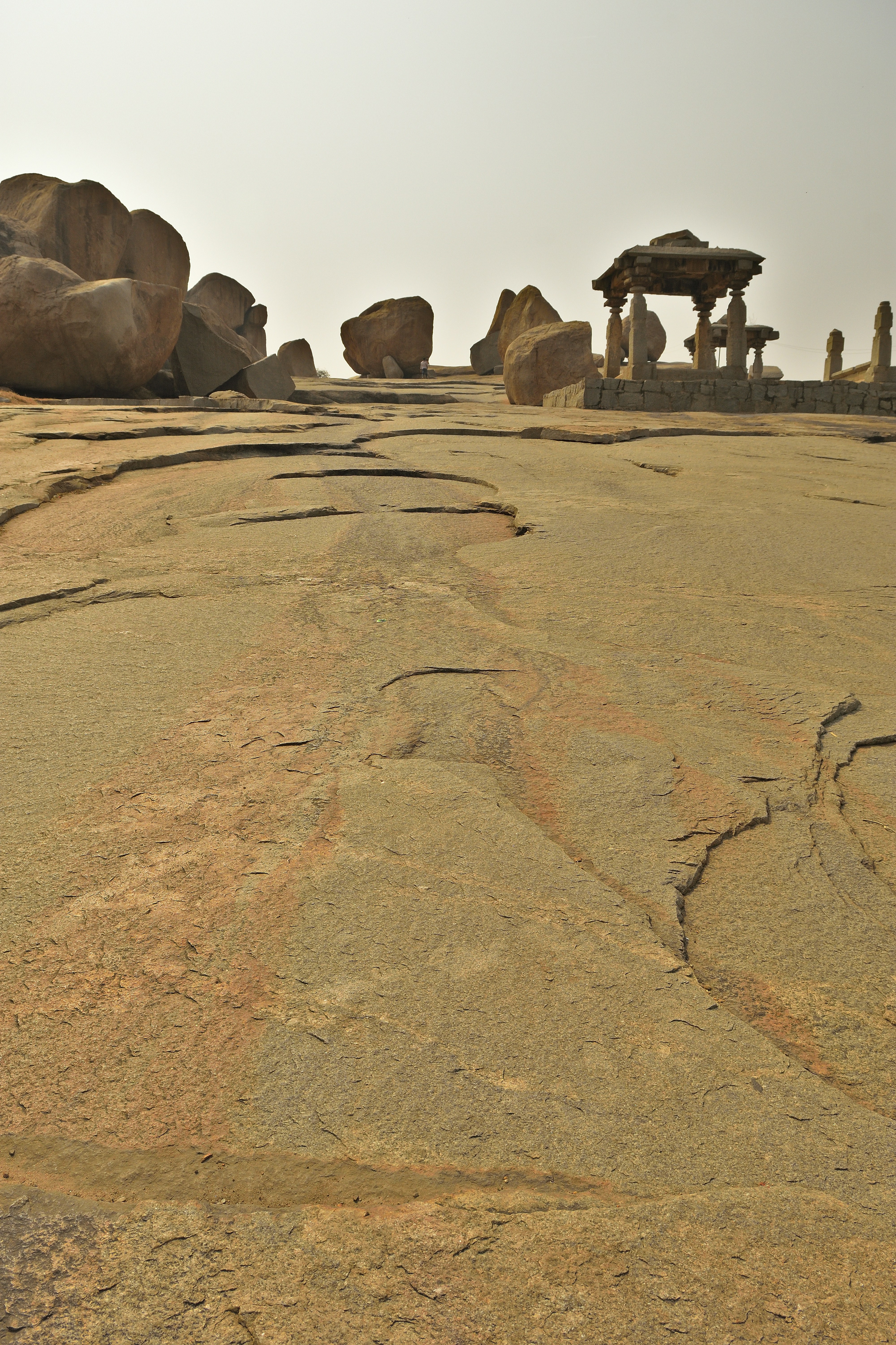 Stone ruins on a rocky landscape under a hazy sky