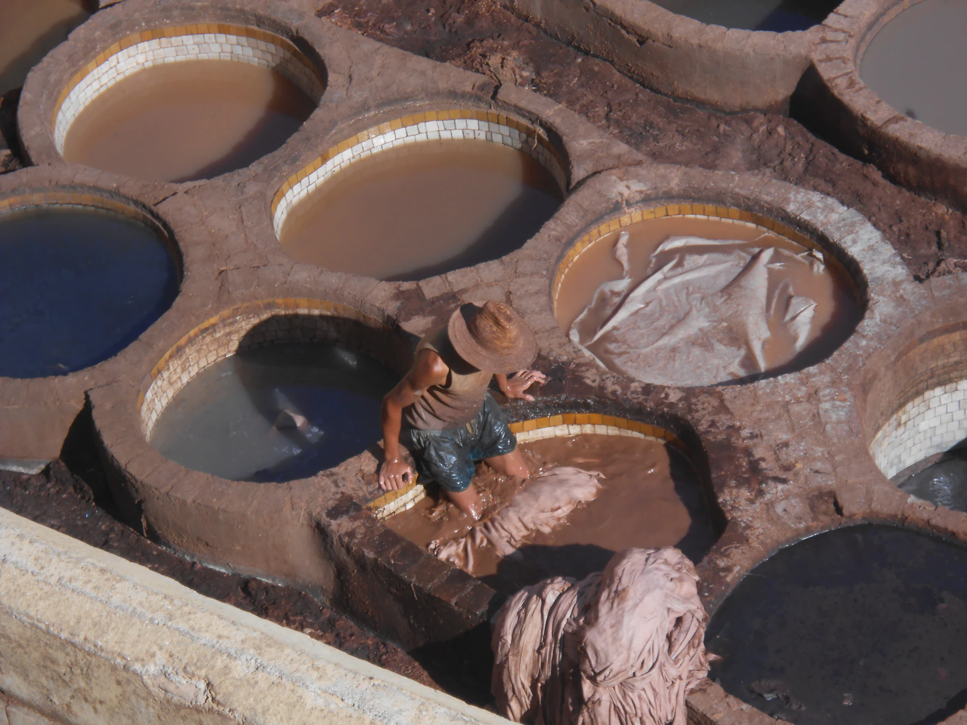 A worker among tannery dye pits
