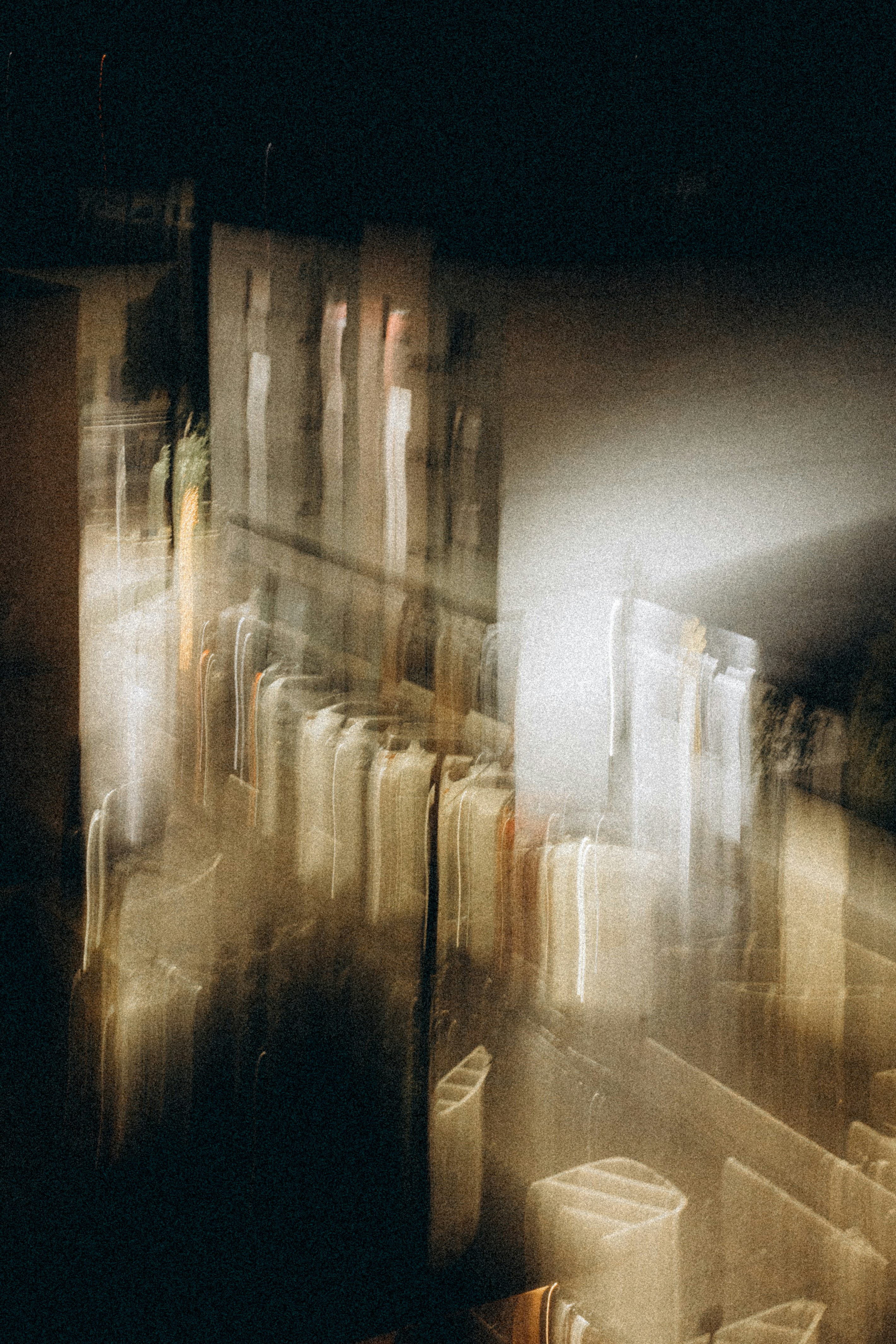 Blurred abstract buildings at night with light streaks.