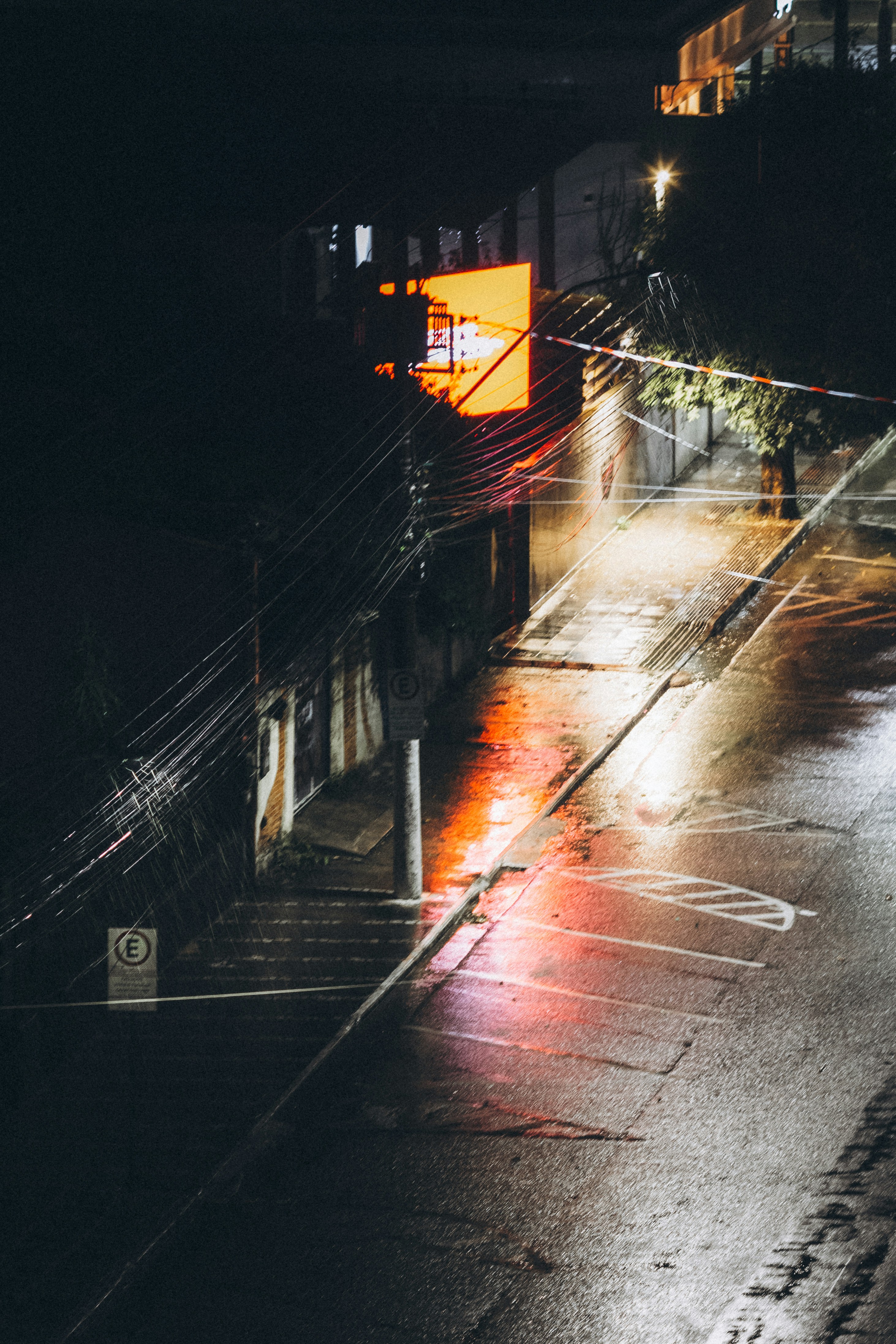 Empty parking lot at night with wet pavement