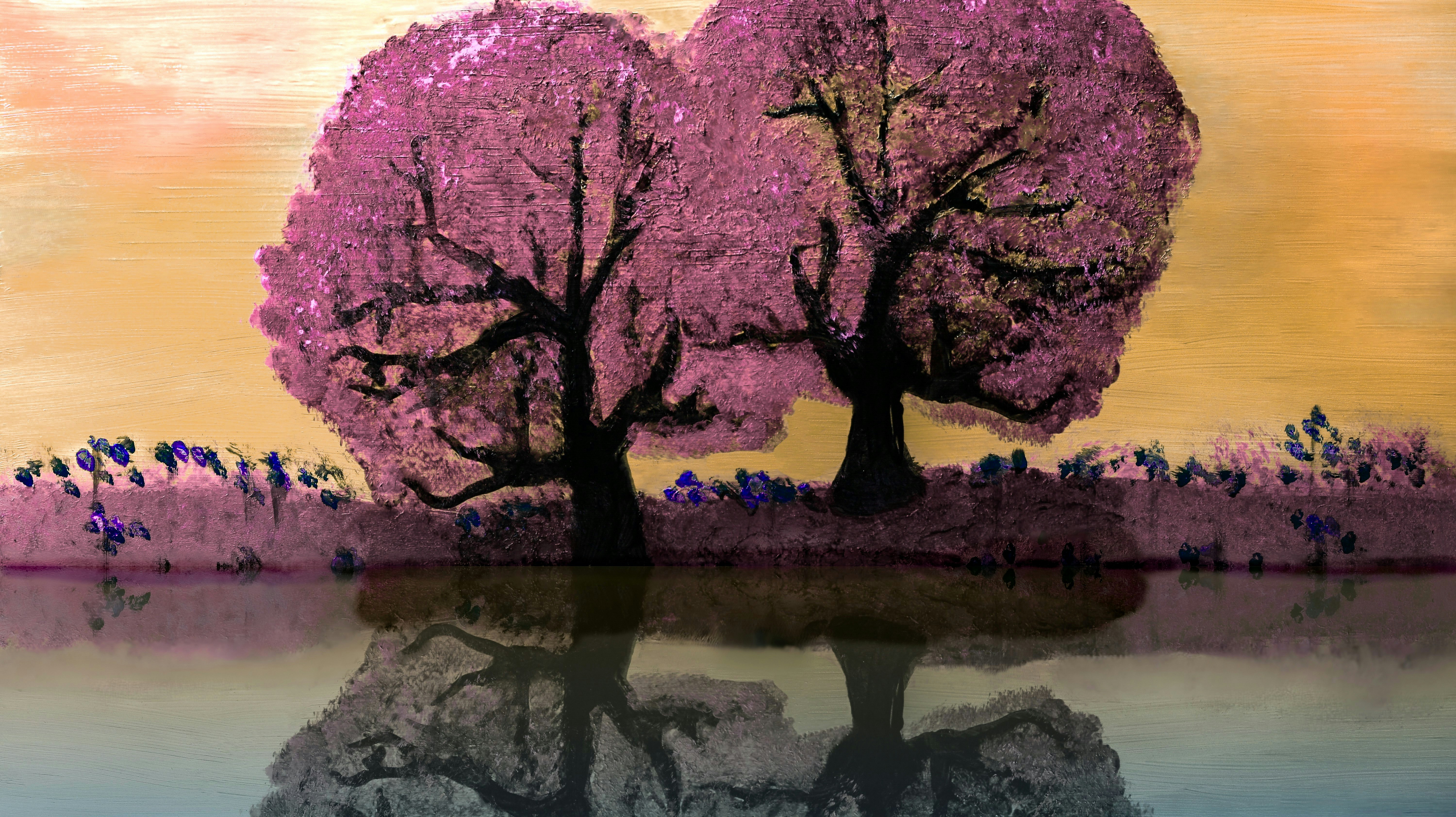 Two pink trees reflected in water at sunset