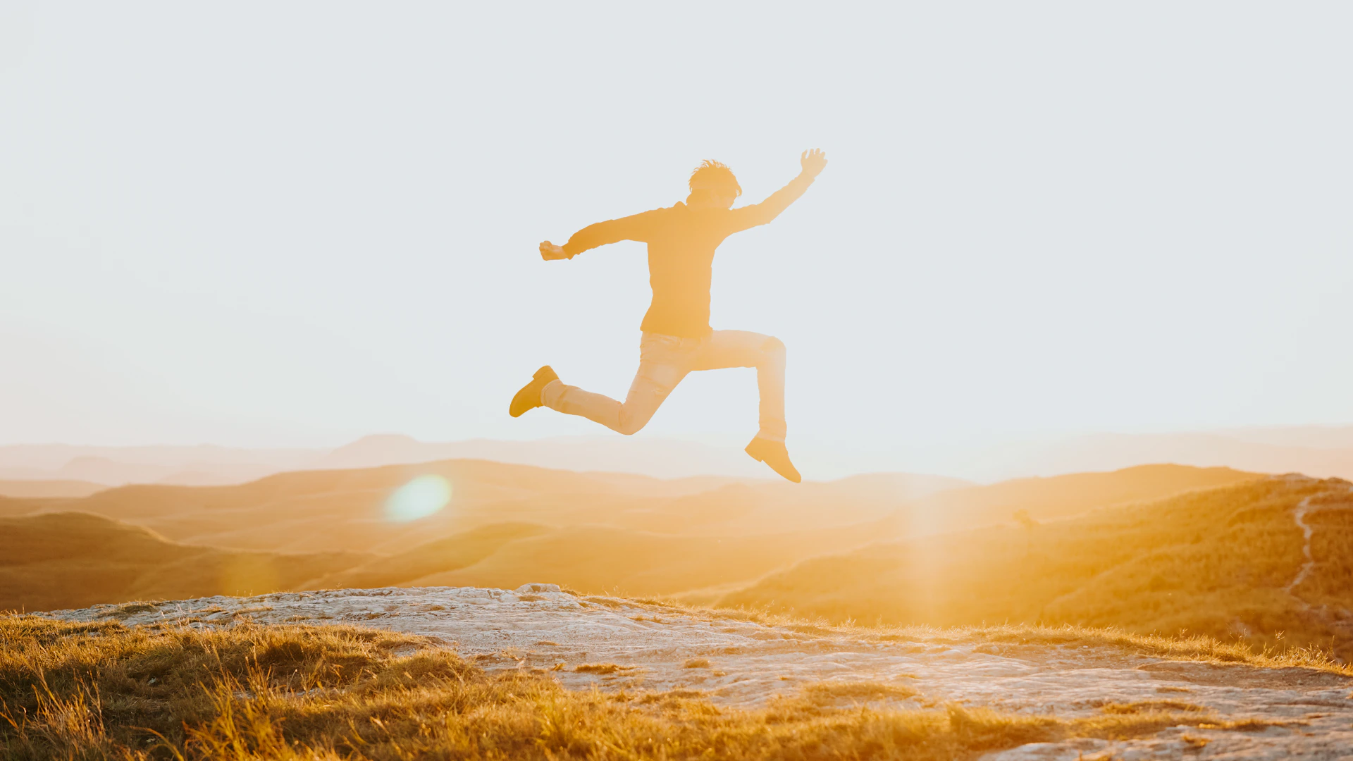 Man jumping in the air at sunset
