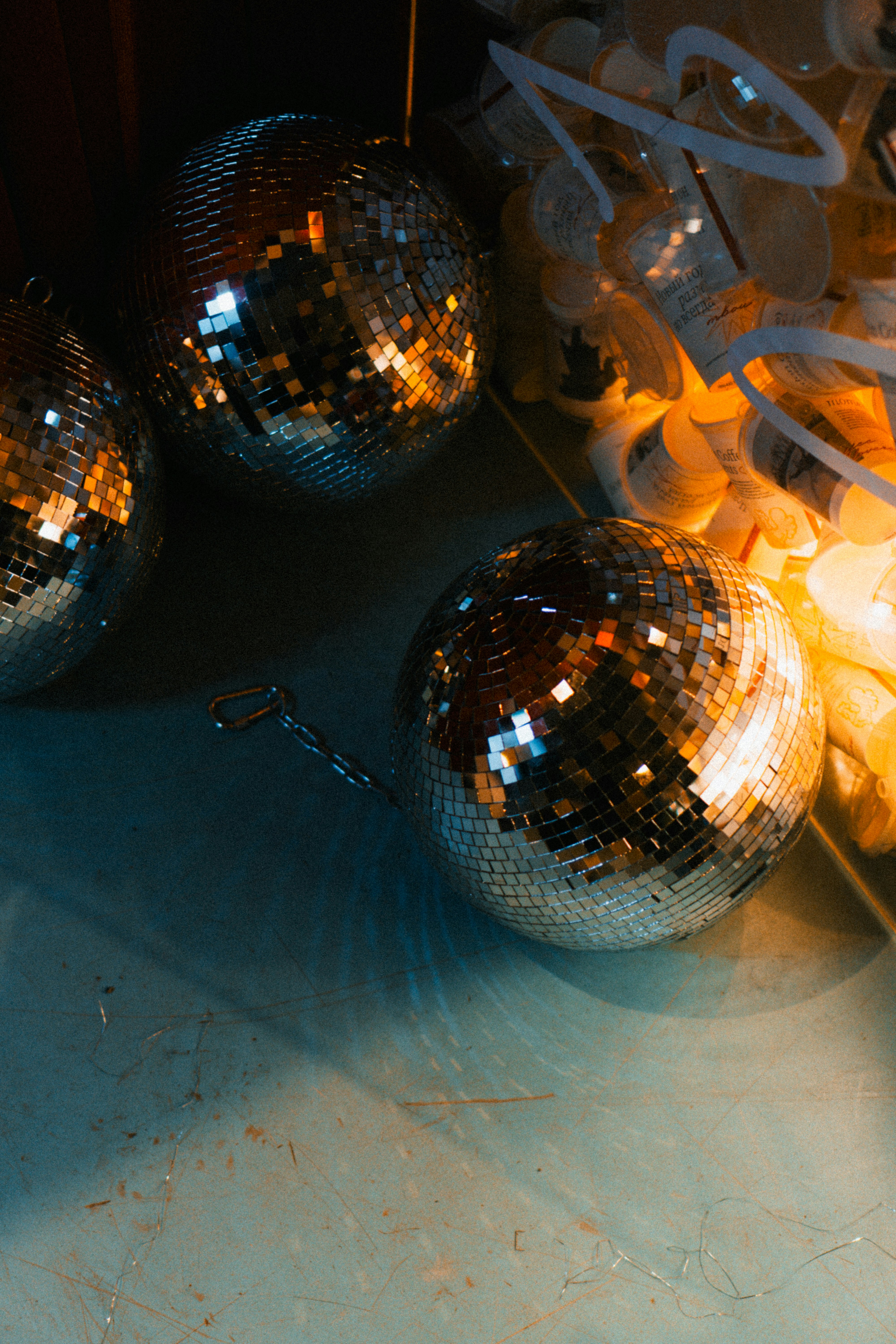 Three disco balls with warm lights in background