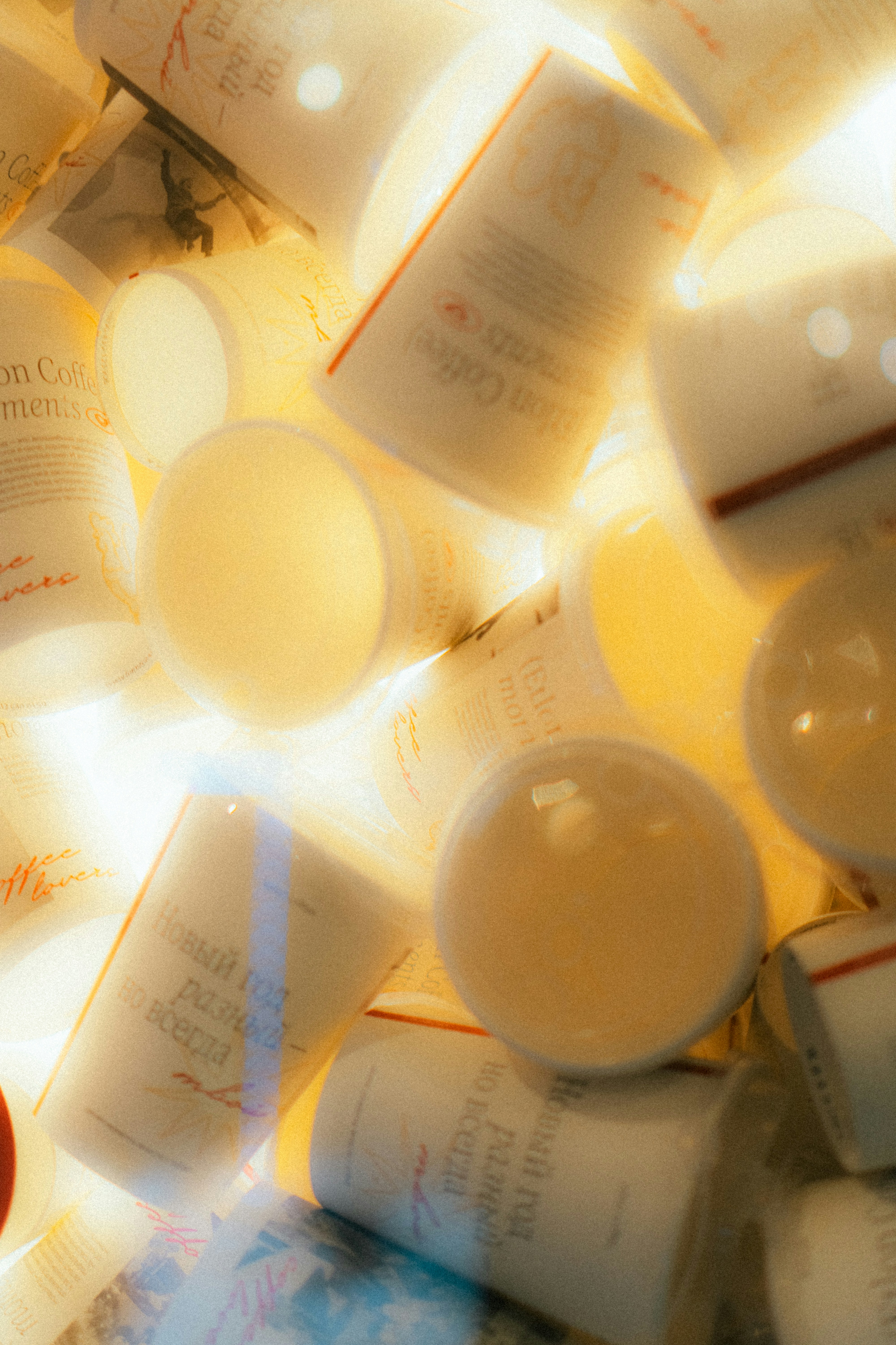 A pile of white cups with red accents